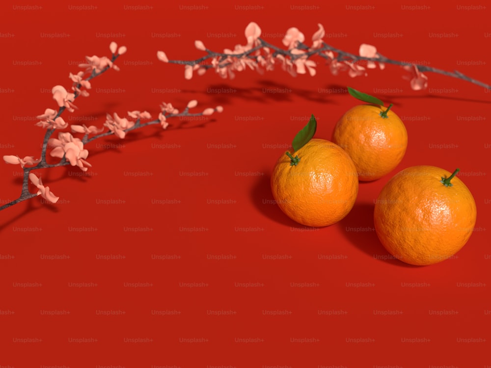 three oranges sitting next to each other on a red surface