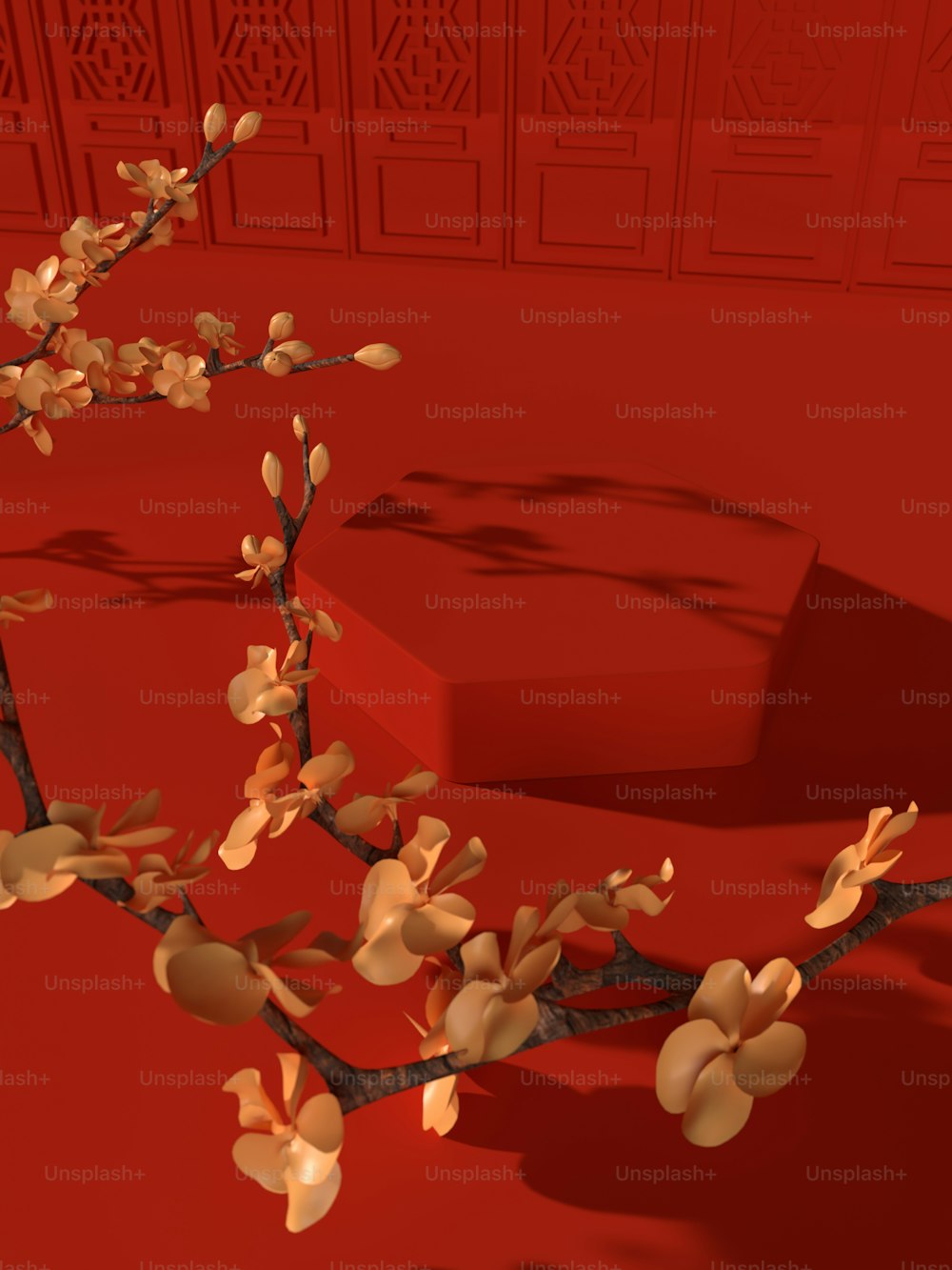 赤い背景に花を持つ枝