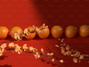 una fila di arance sedute in cima a un tavolo rosso
