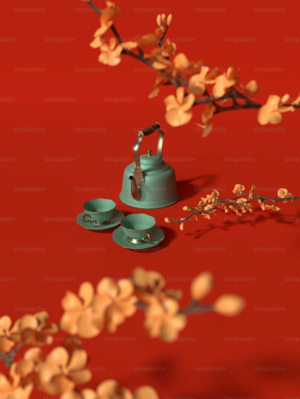 un bollitore per il tè e due tazze su una superficie rossa