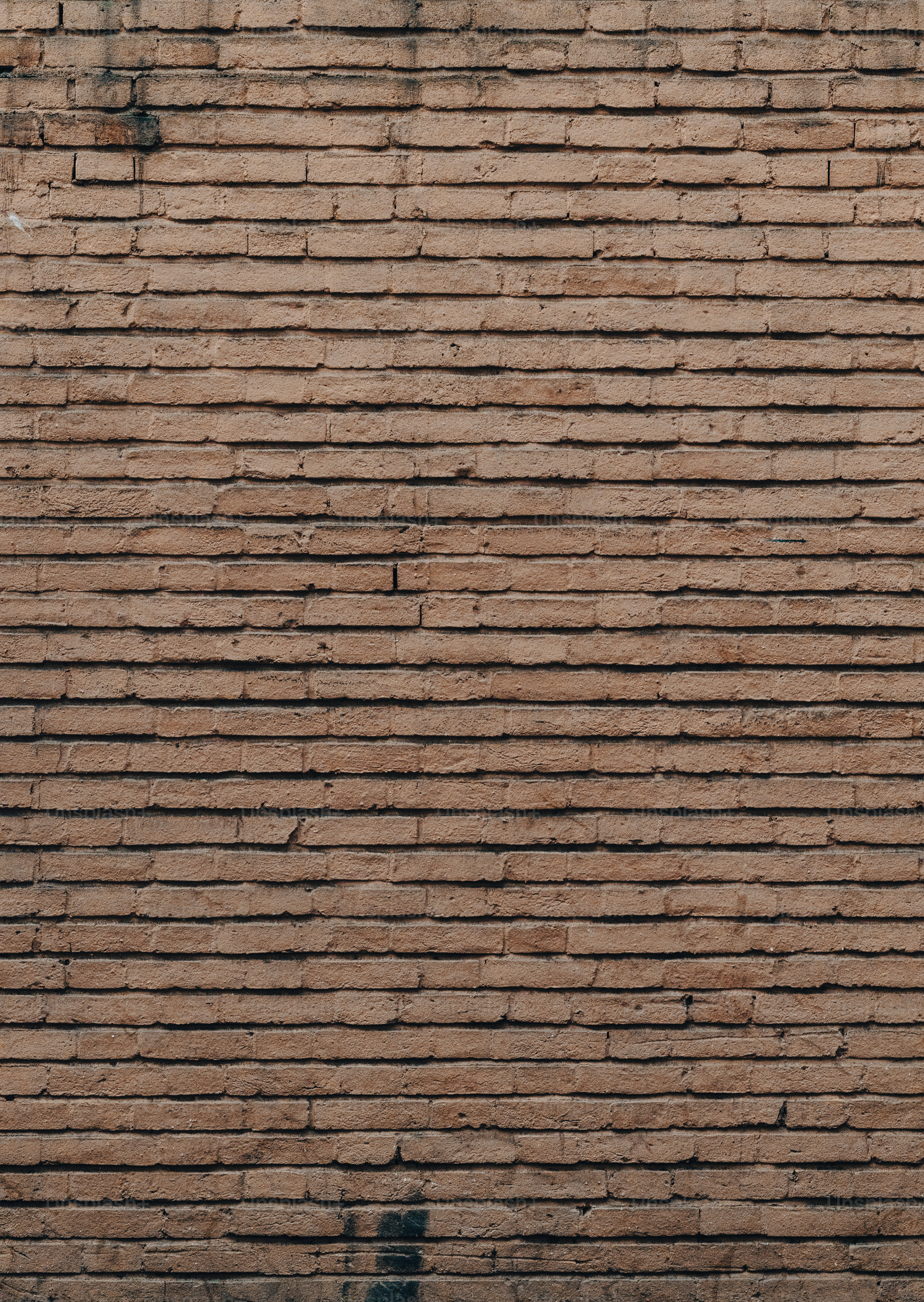 a clock on the side of a brick wall