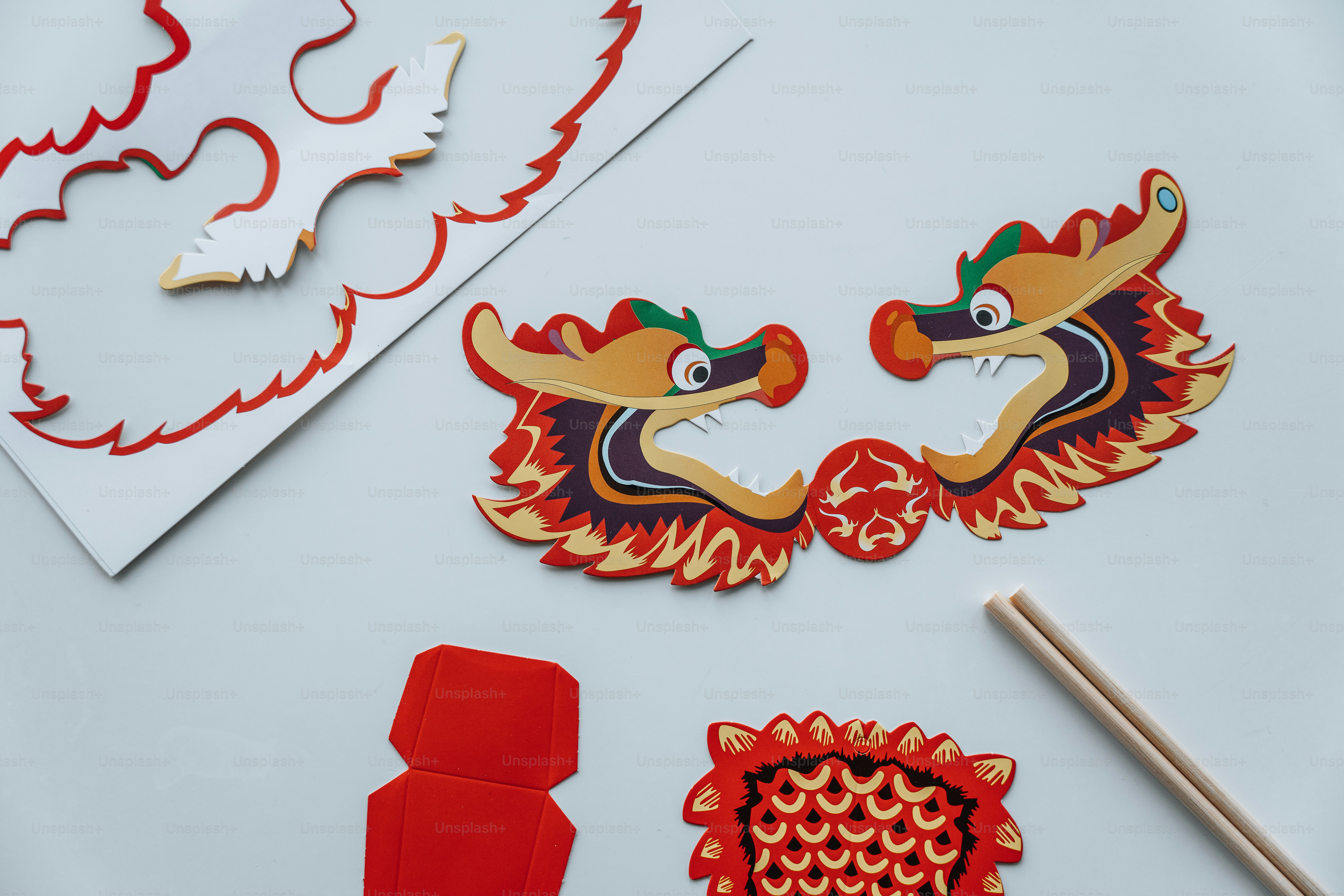 a white table topped with cut outs and paper