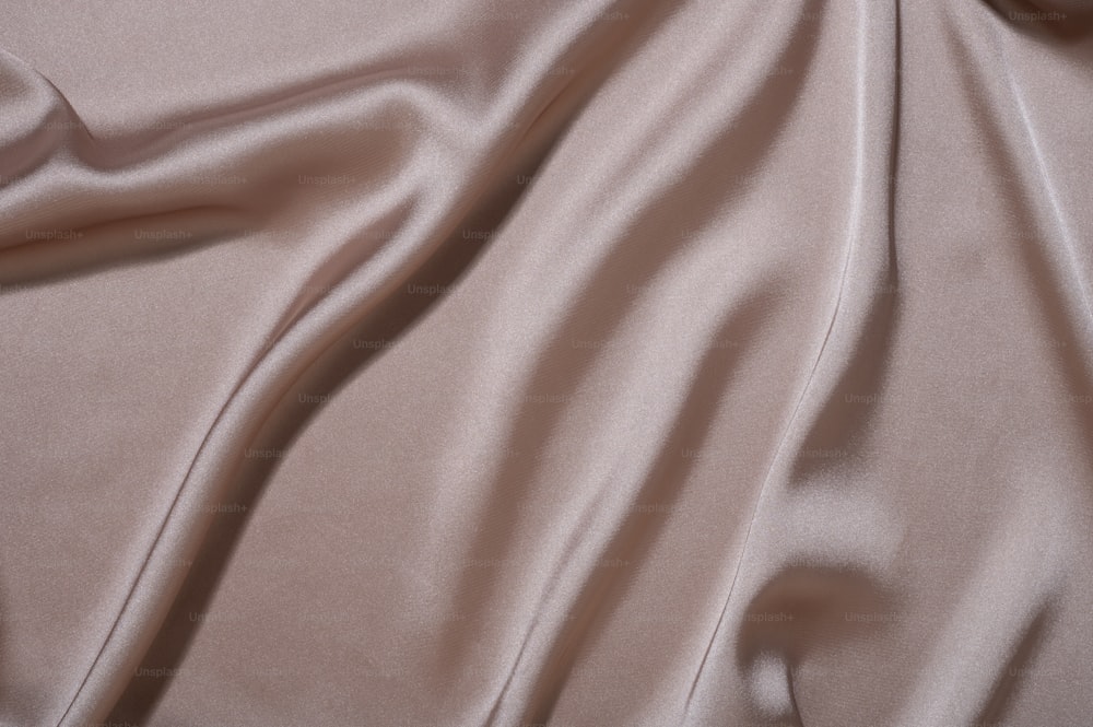 a close up view of a light pink fabric
