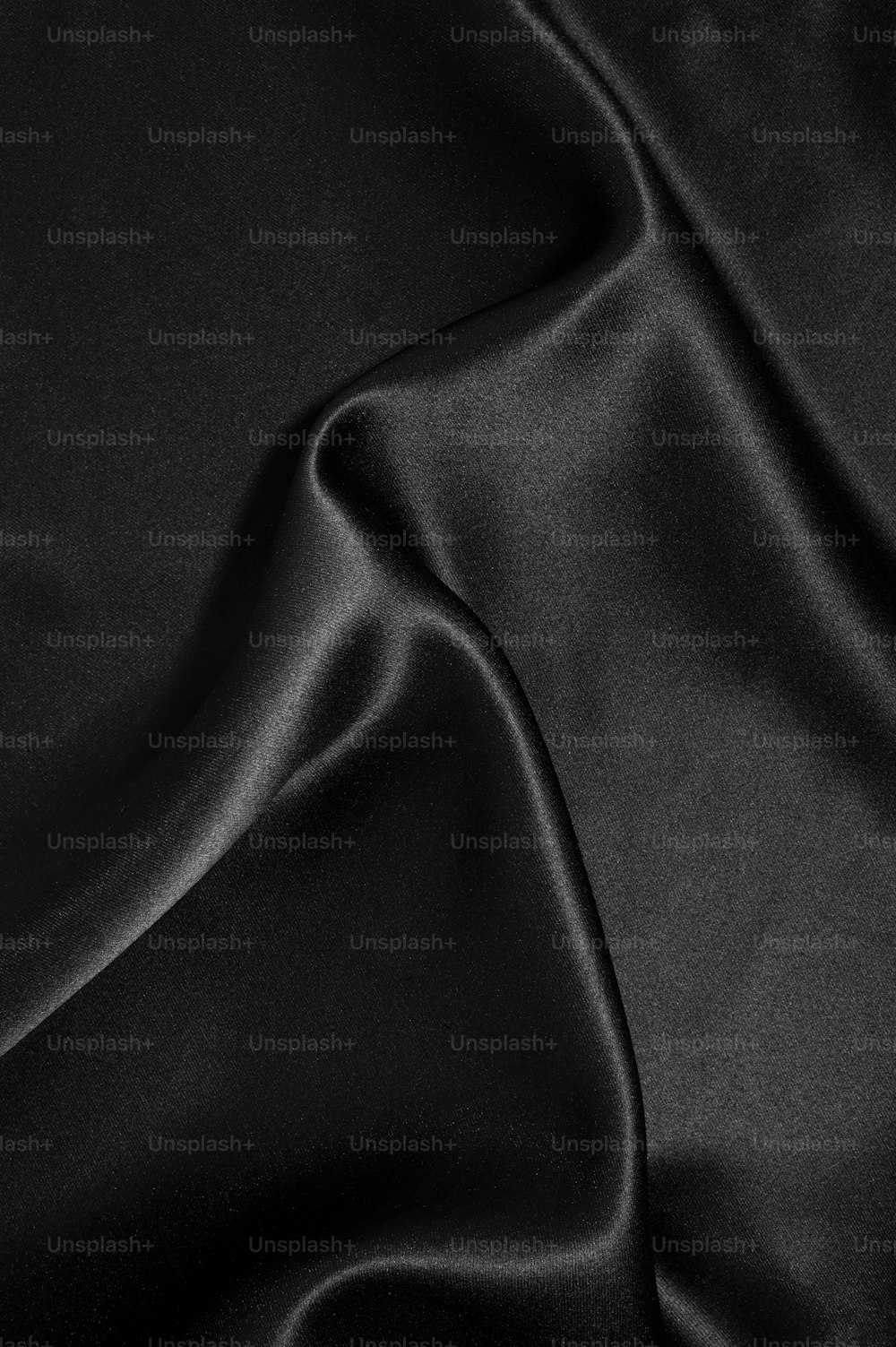 a close up of a black satin material