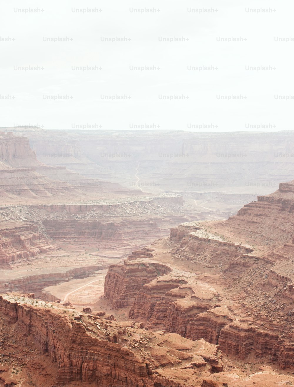 a man standing on top of a cliff overlooking a canyon