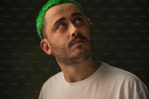 a man with green hair and a white t - shirt