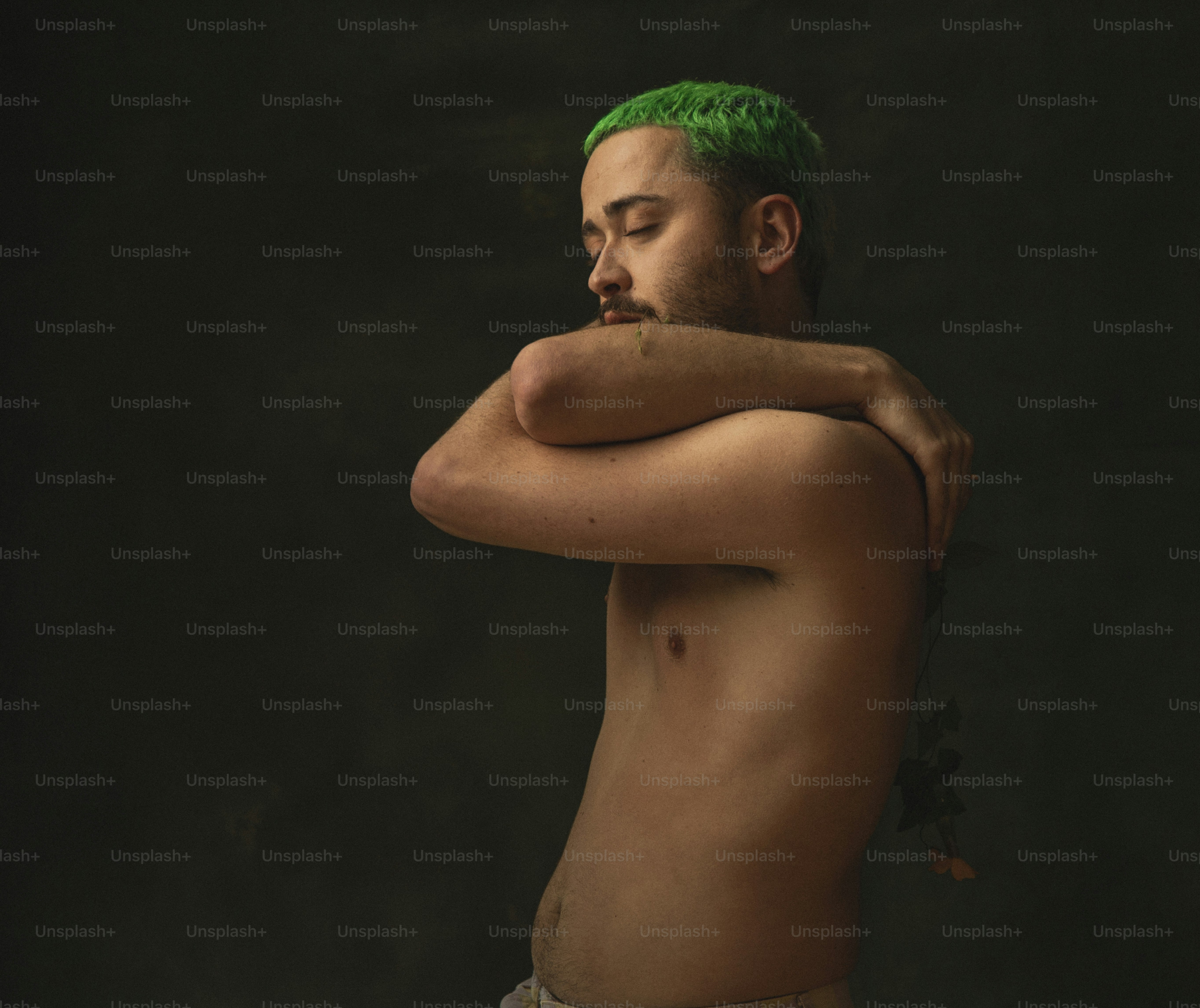 a man with green hair and no shirt