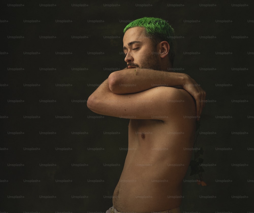 a man with green hair and no shirt