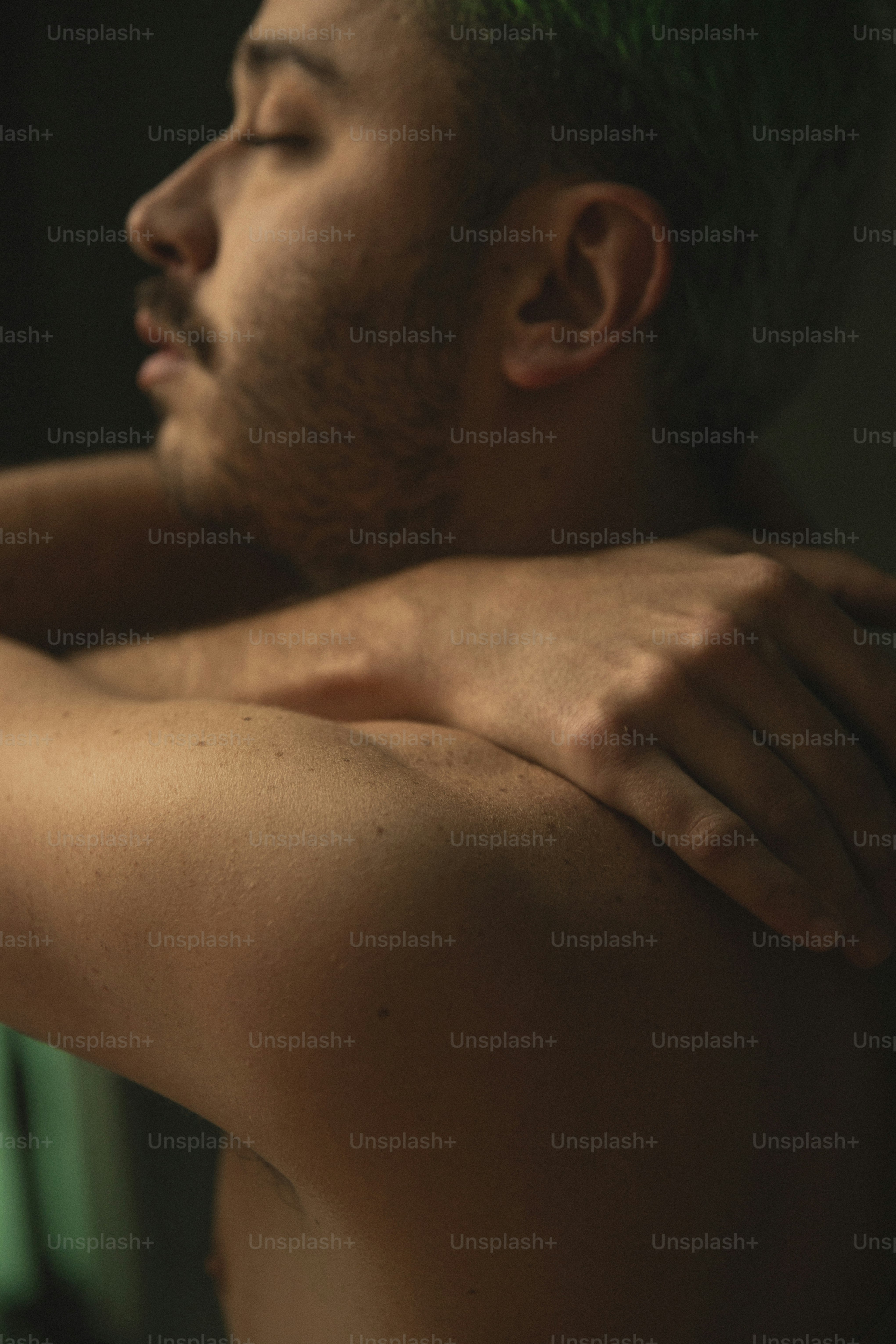 a man with green hair is holding a cell phone