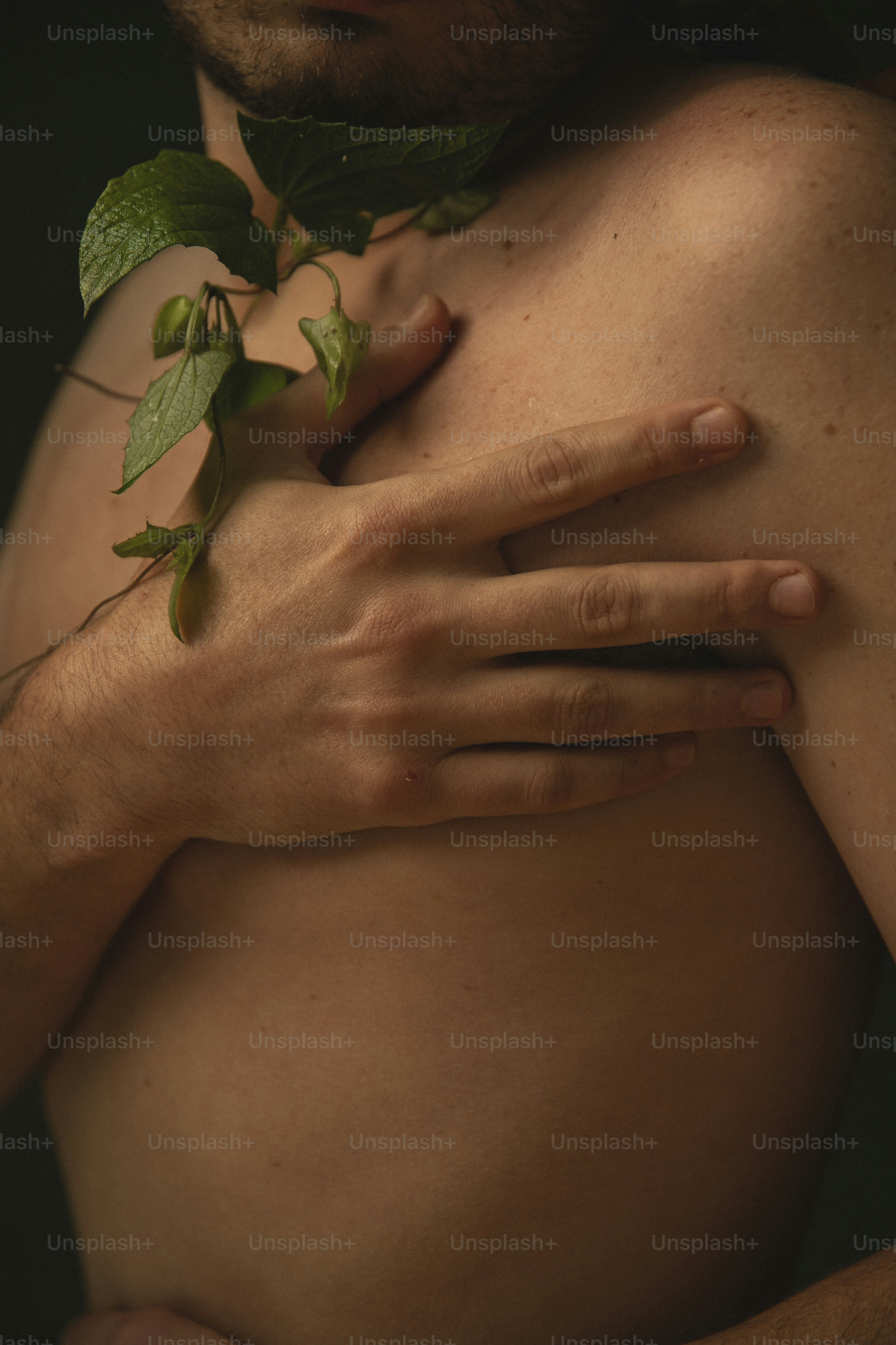 a close up of a person with a leaf on his chest