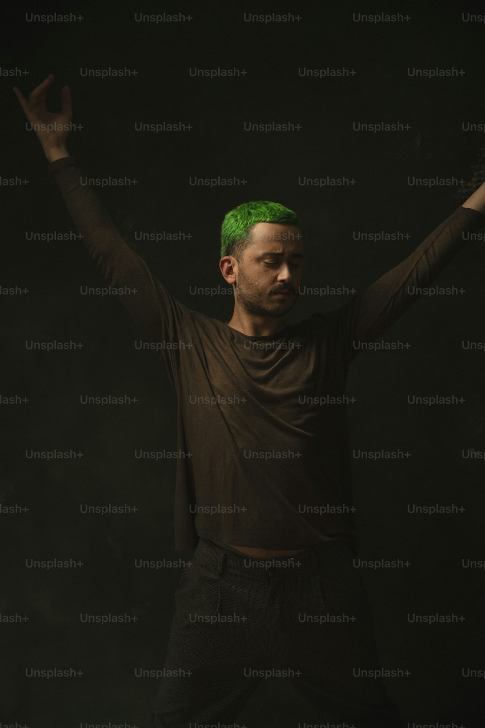 a man with green hair and a brown shirt