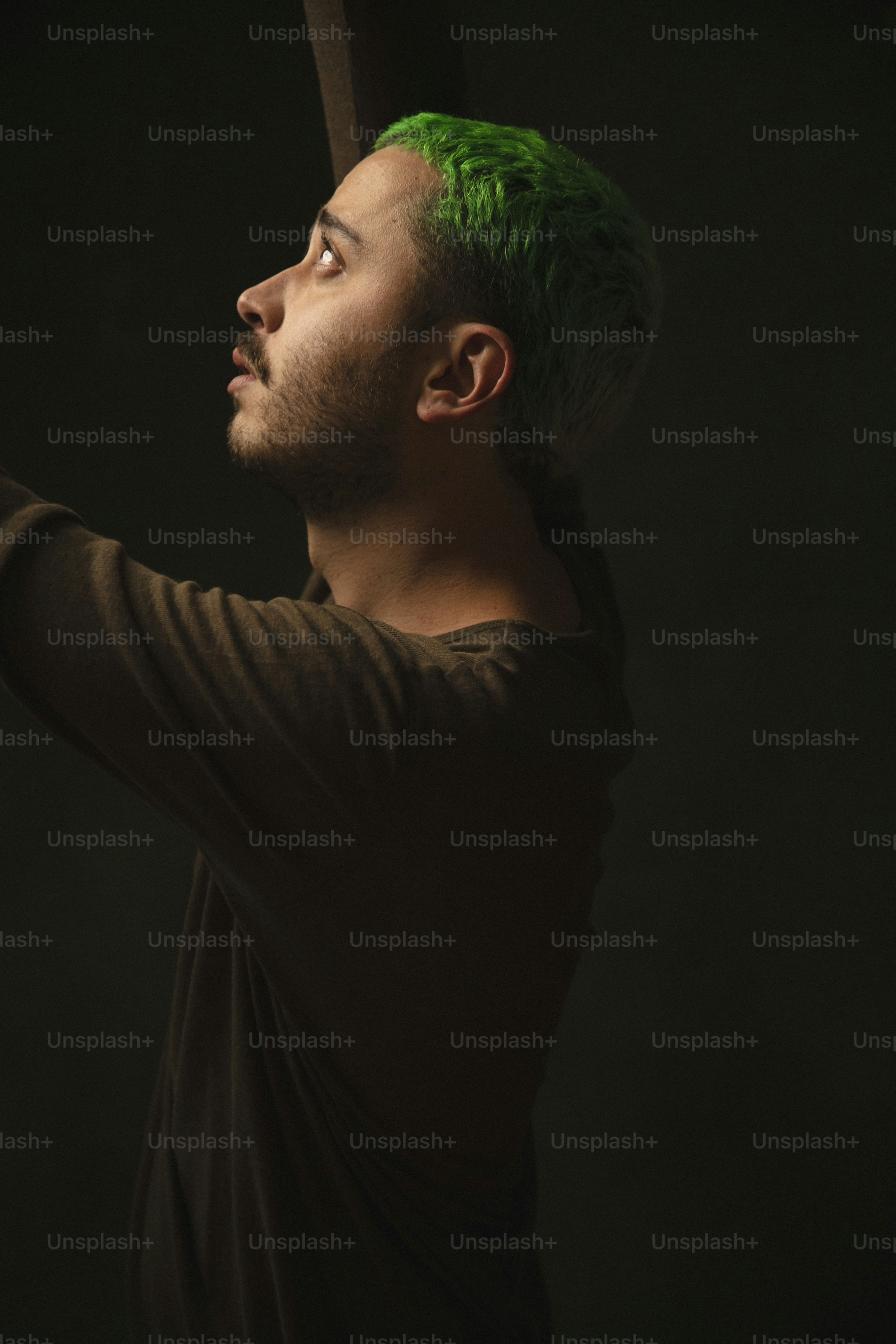 a man with green hair holding a baseball bat