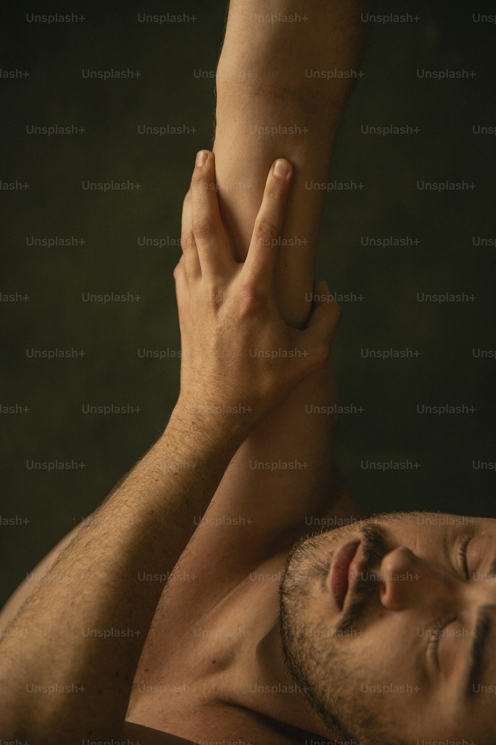a man laying down with his hands on his chest