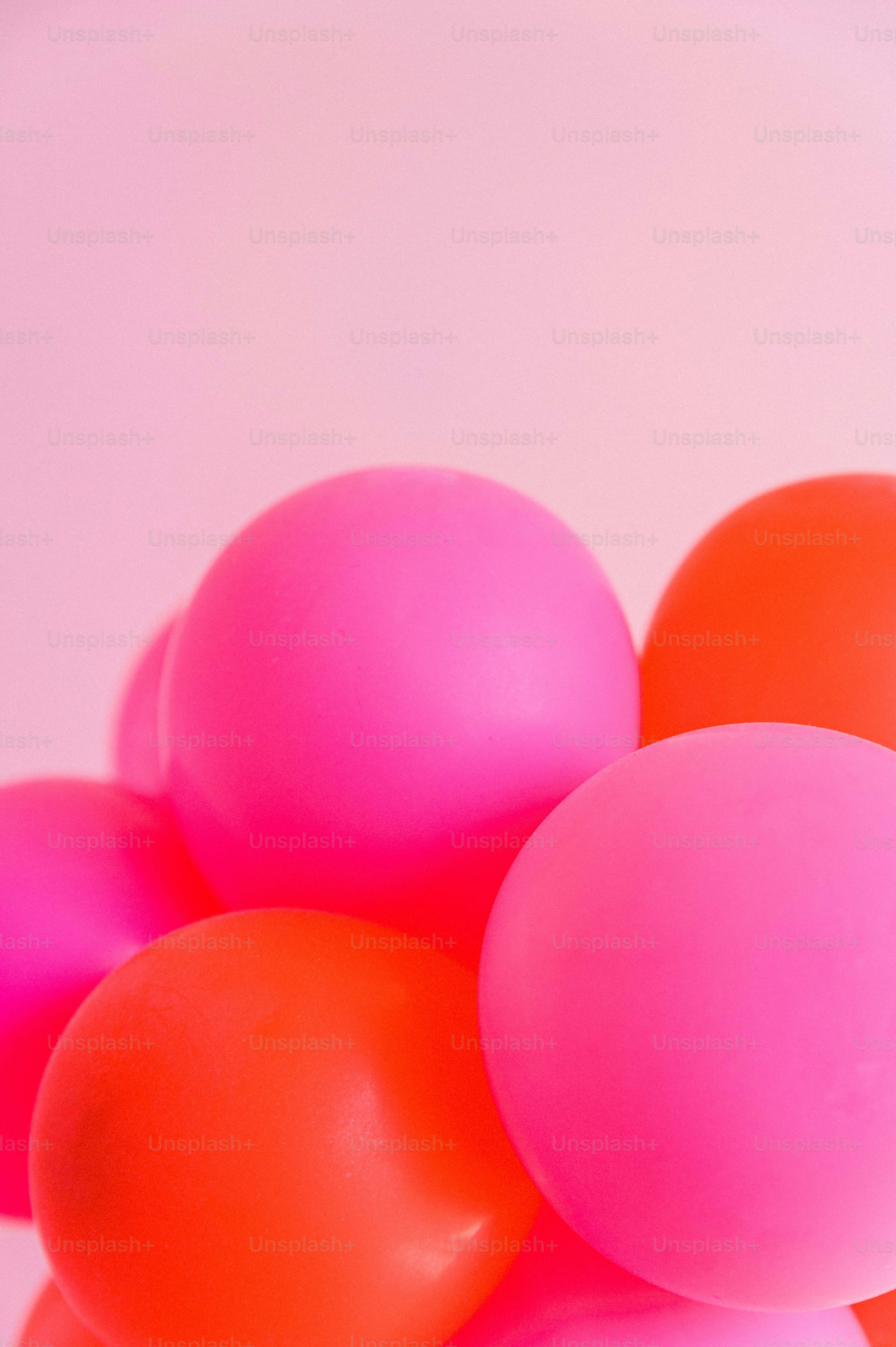A bunch of pink and orange balloons on a table photo February 14th