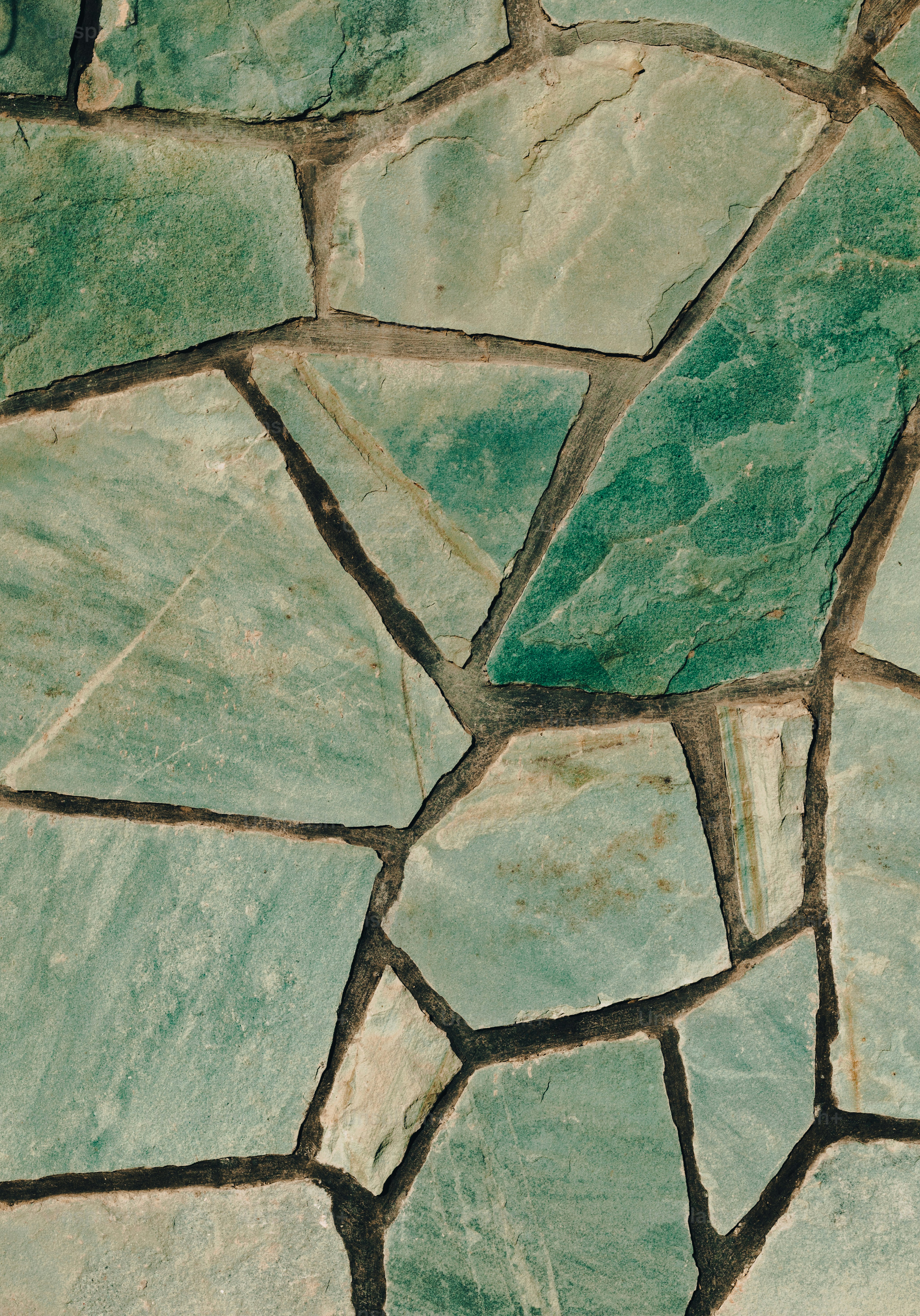 a close up of a stone wall with a clock on it