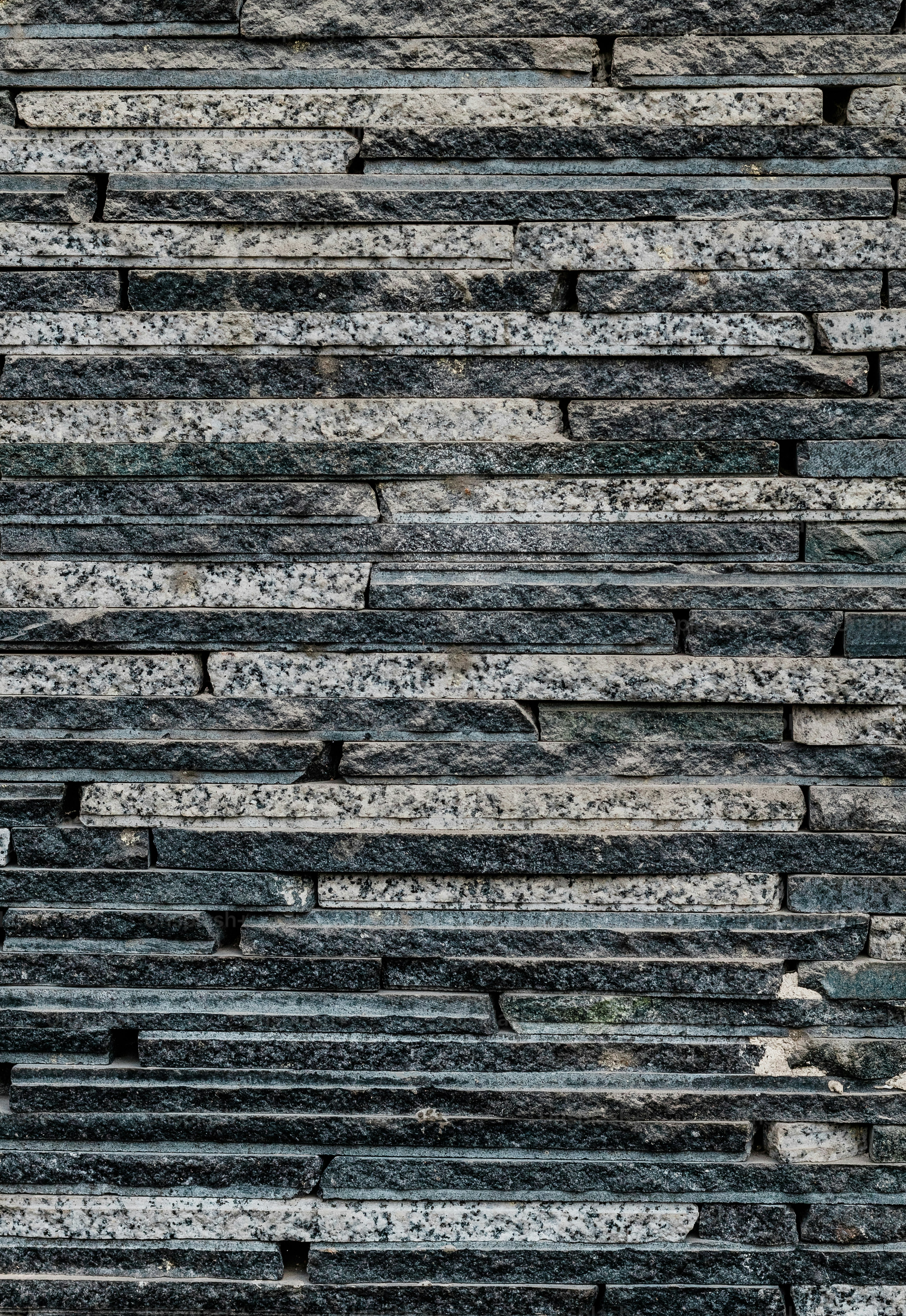 a black and white photo of a stone wall