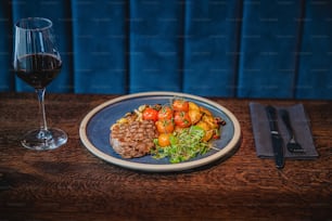 a plate of food and a glass of wine on a table