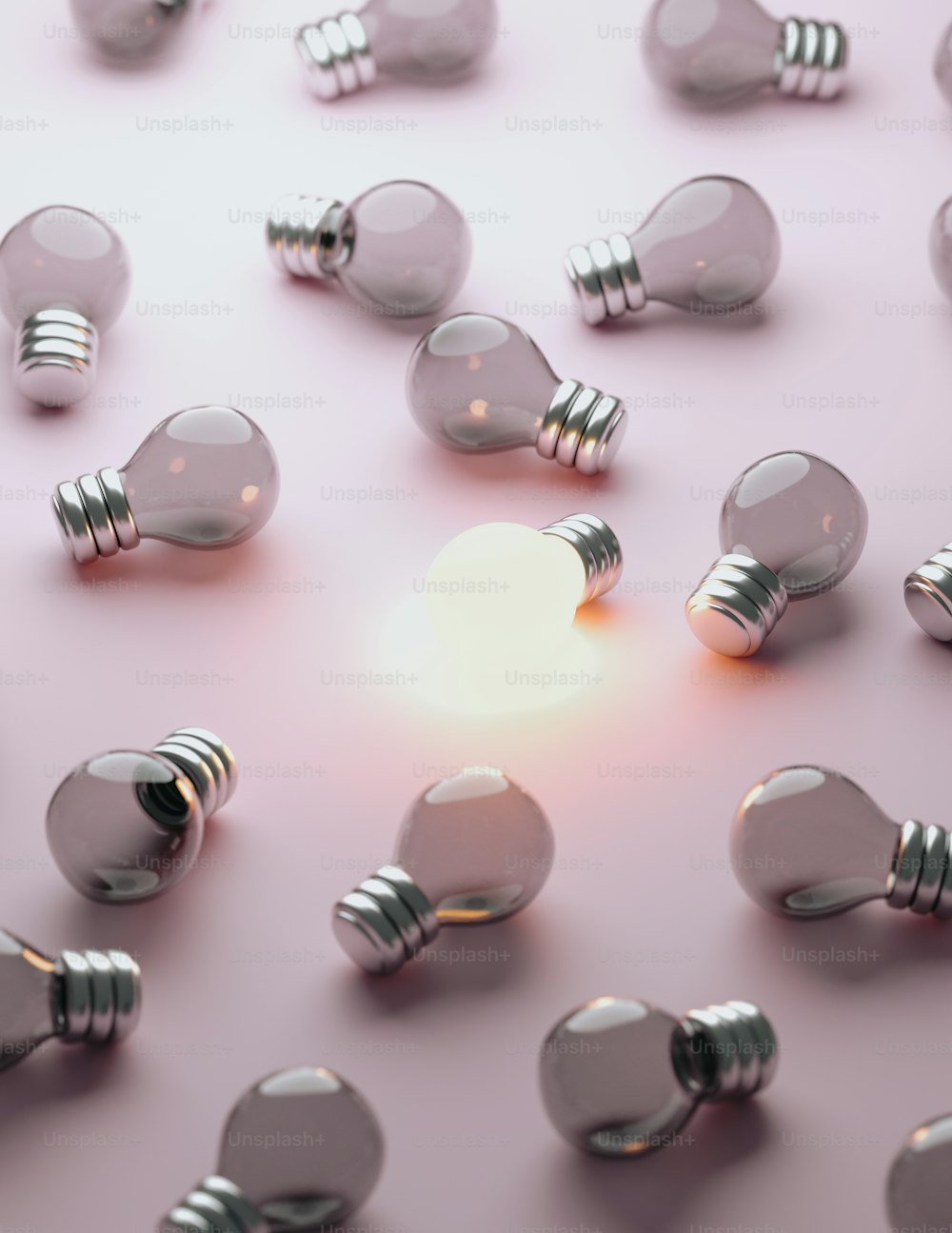 a group of light bulbs on a pink surface