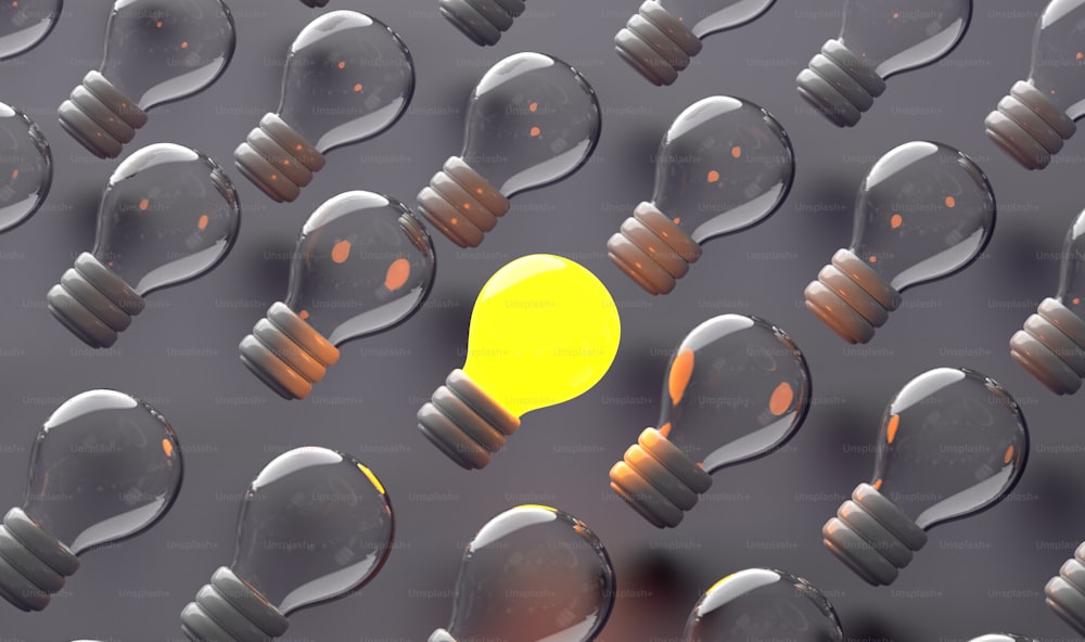 a yellow light bulb surrounded by many black ones