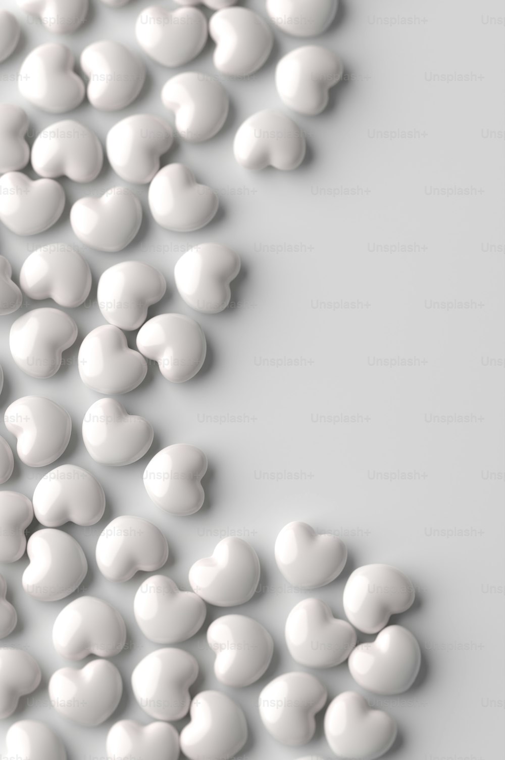 a bunch of white pills are scattered on a white surface