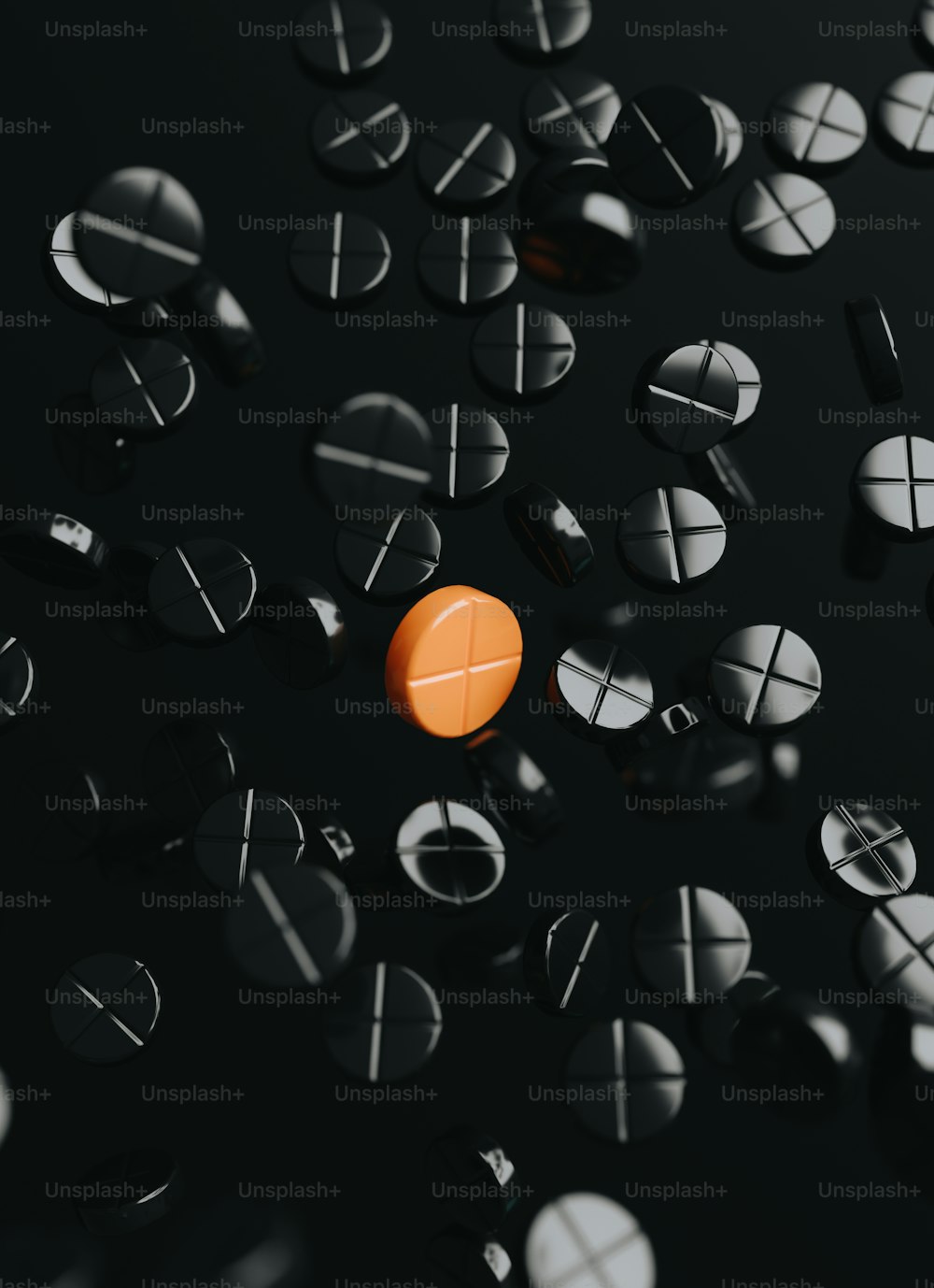 an orange pill sitting on top of a black surface