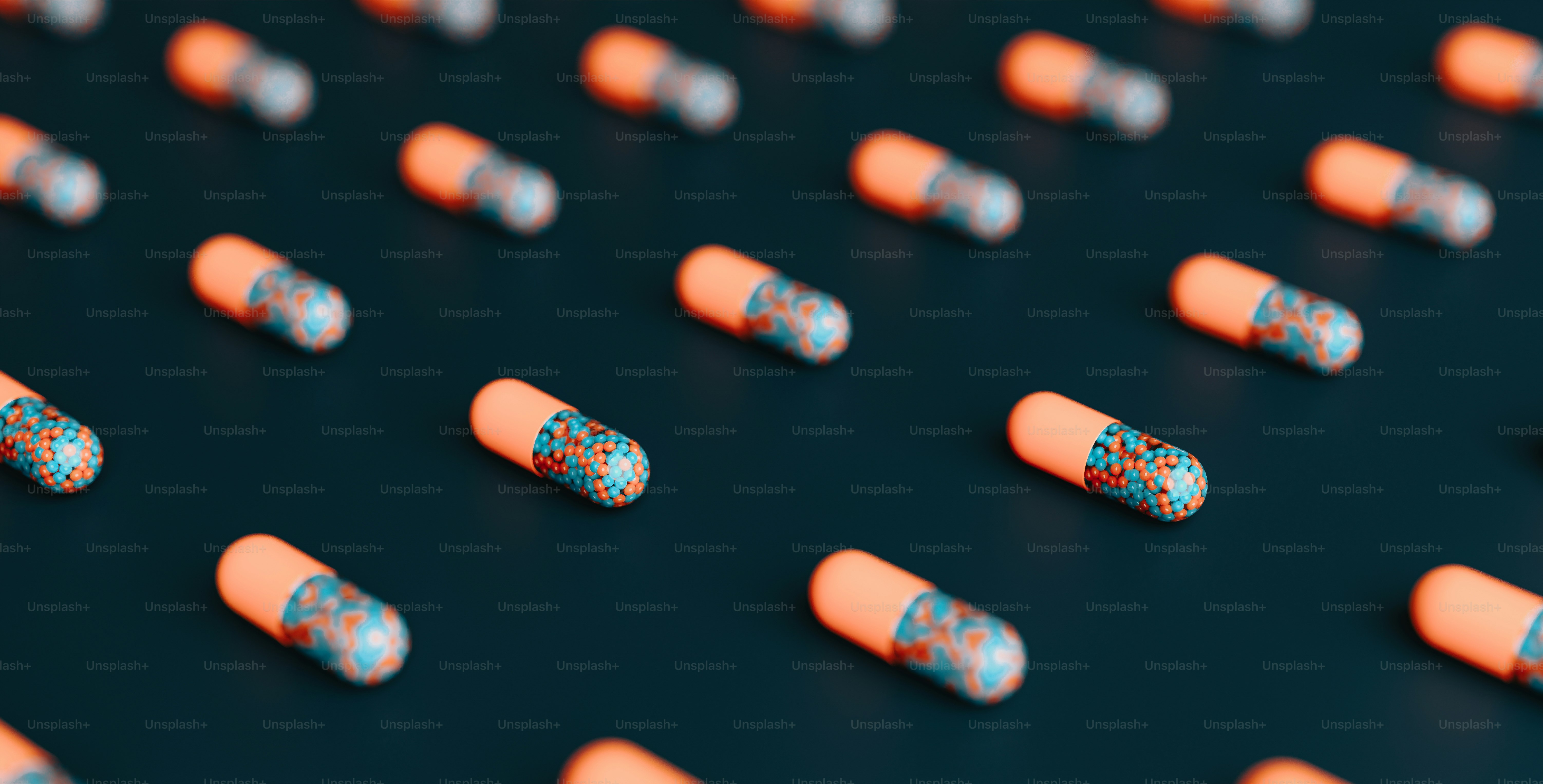 a group of orange and blue pills sitting on top of a table