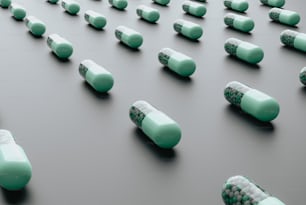 a group of green and white pills sitting on top of a table