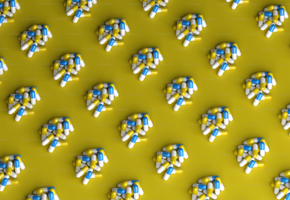 a group of pills sitting on top of a yellow surface