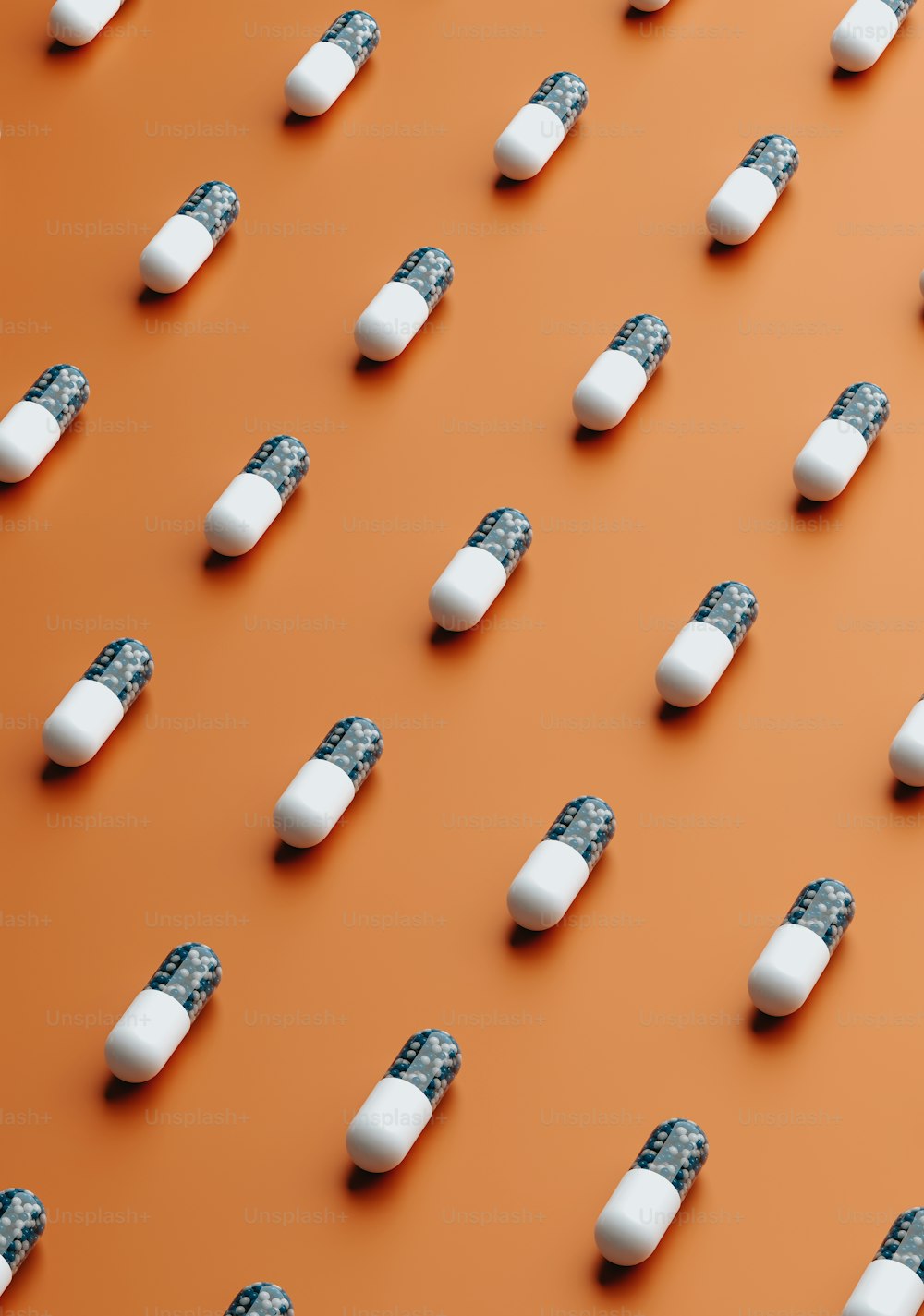 a group of pills sitting on top of an orange surface