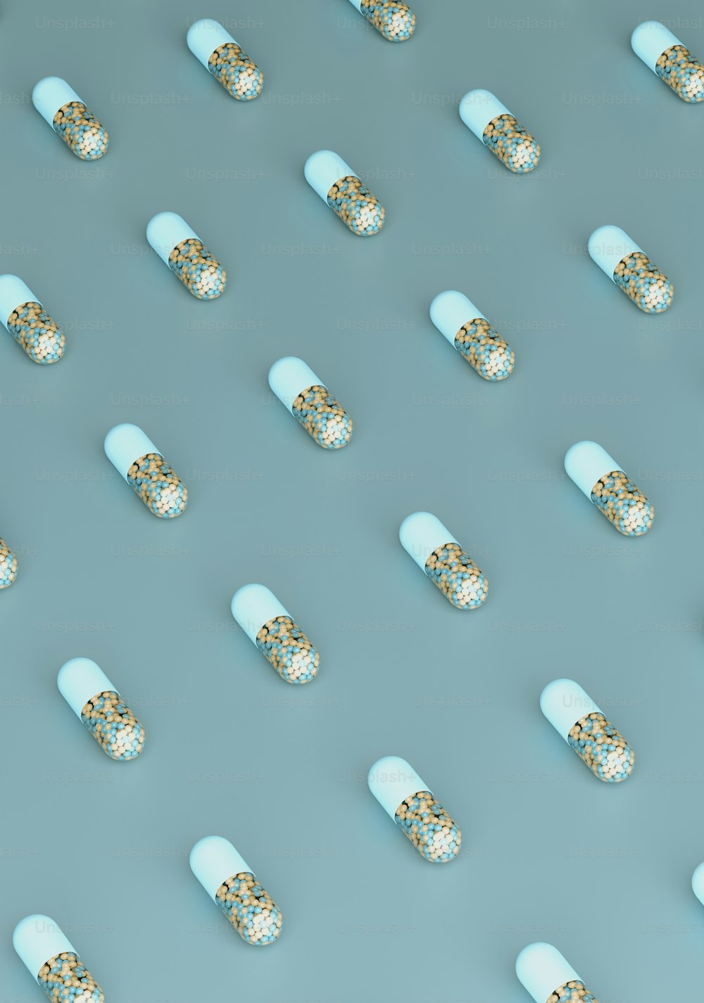 many pills are arranged in rows on a blue surface