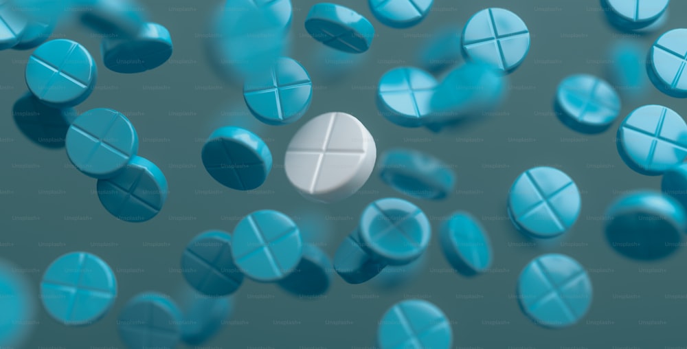 a group of blue and white pills floating in the air