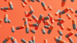 a lot of pills are scattered on an orange background