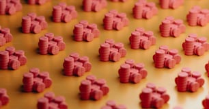 a large group of small red objects on a table
