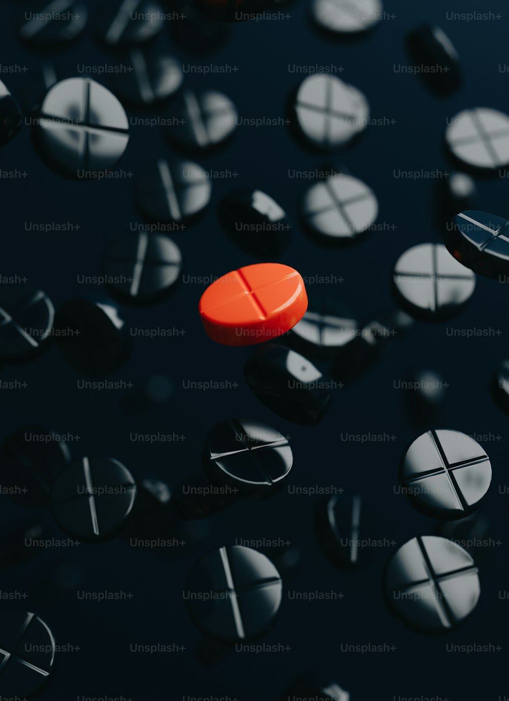 a red pill sitting on top of a black surface