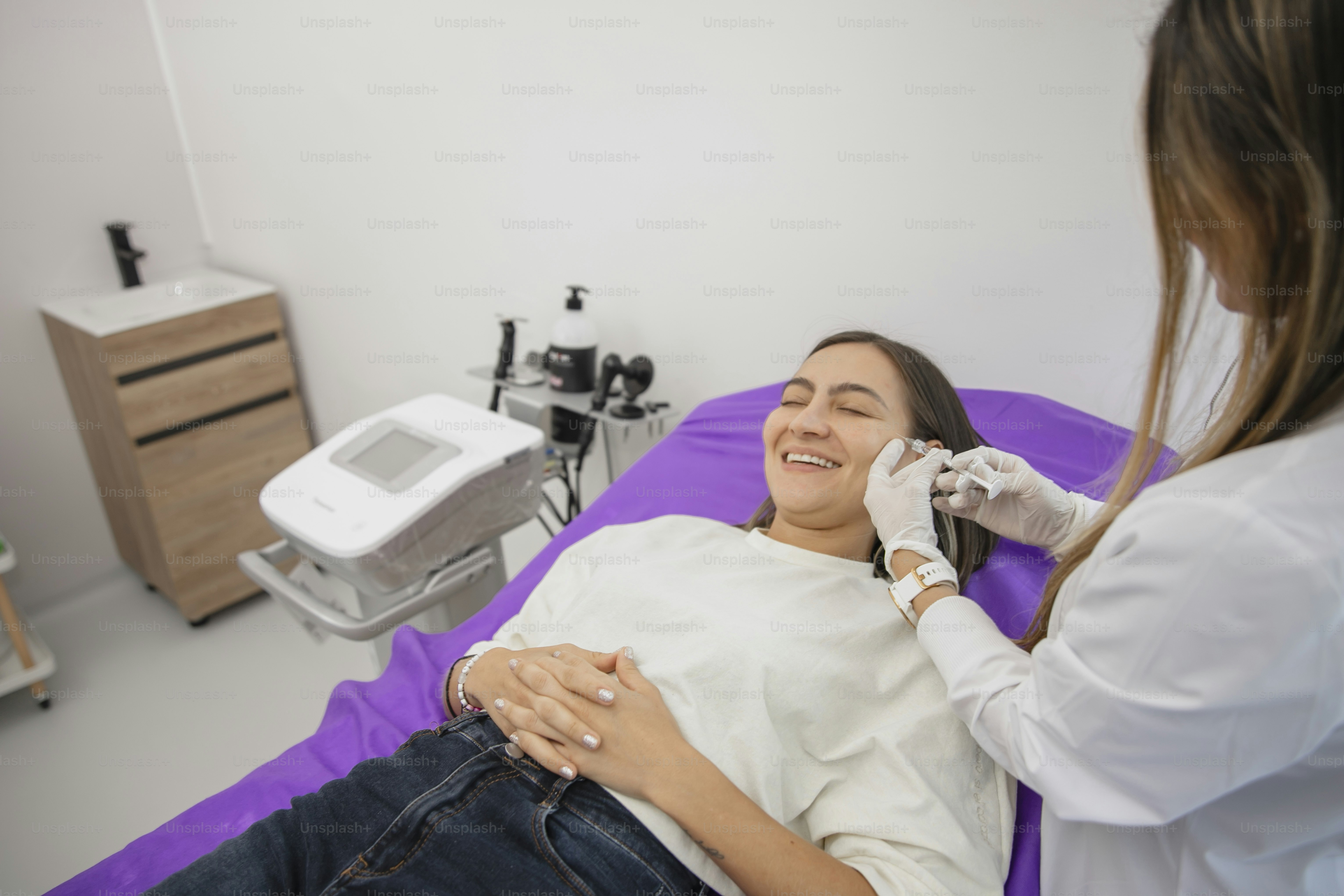 a woman getting her teeth checked by a doctor