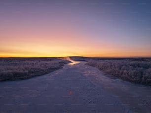 a river running through a snow covered field