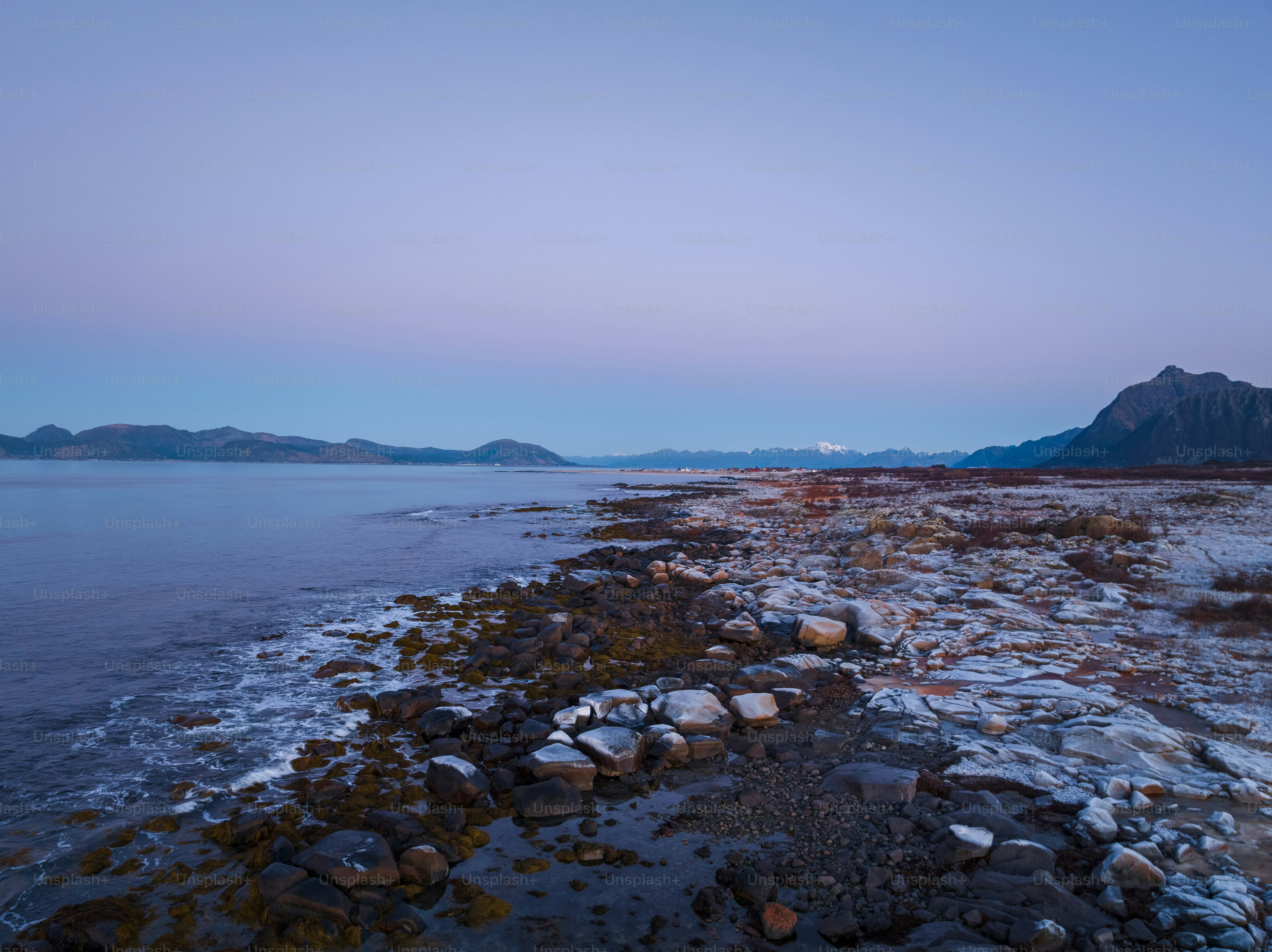 a view of a body of water with mountains in the background