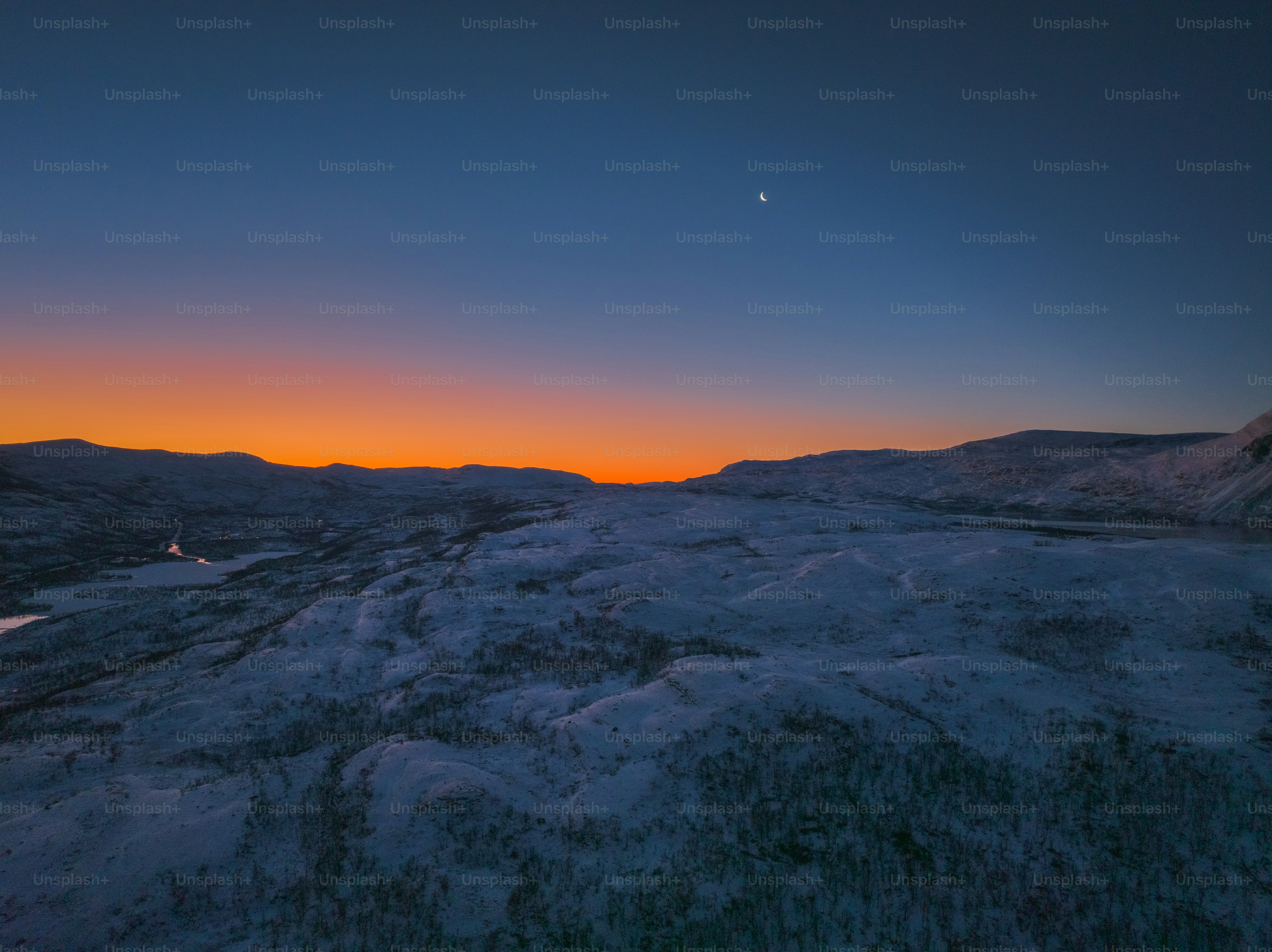 the sun is setting over a mountain range
