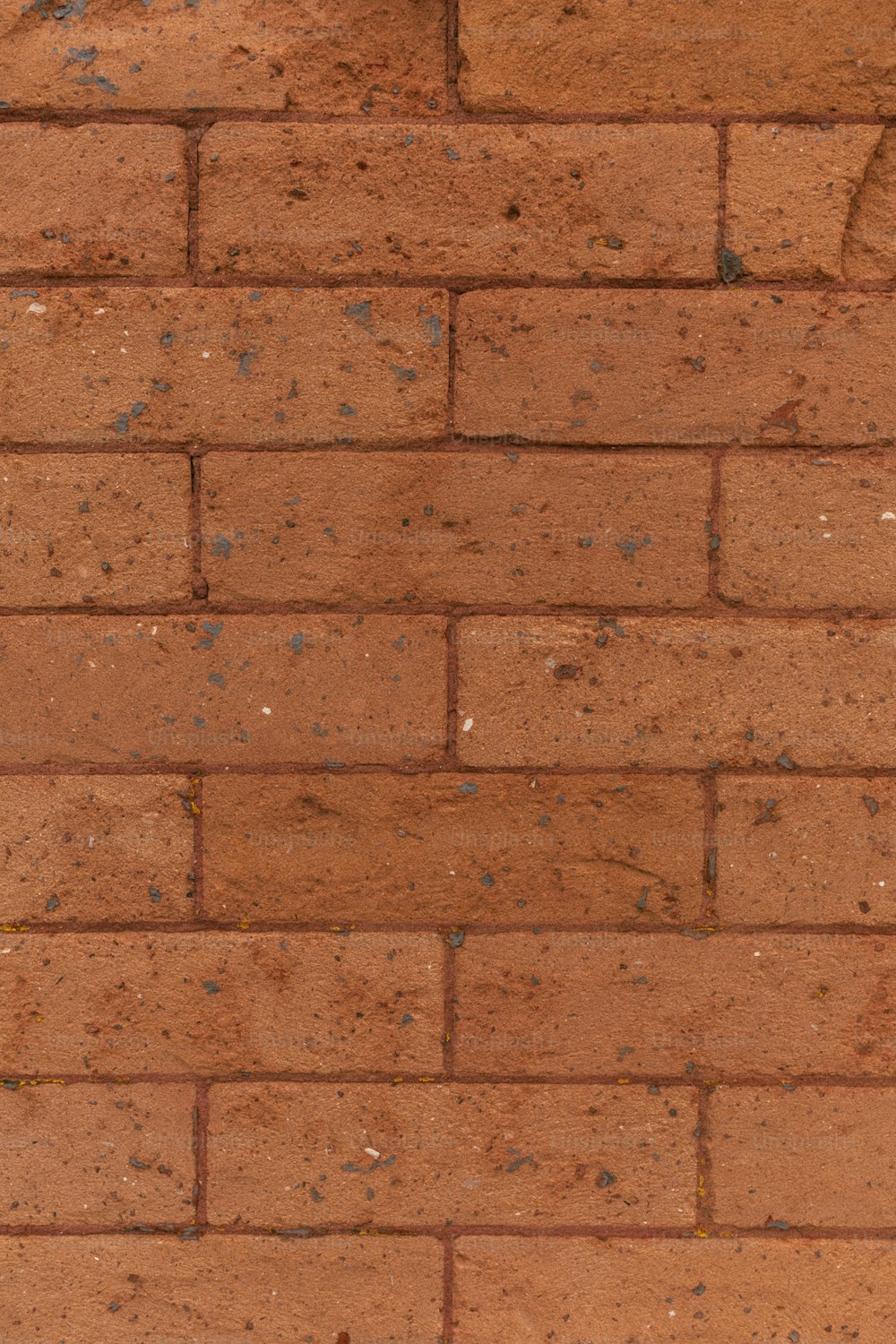 a red brick wall with a clock on it