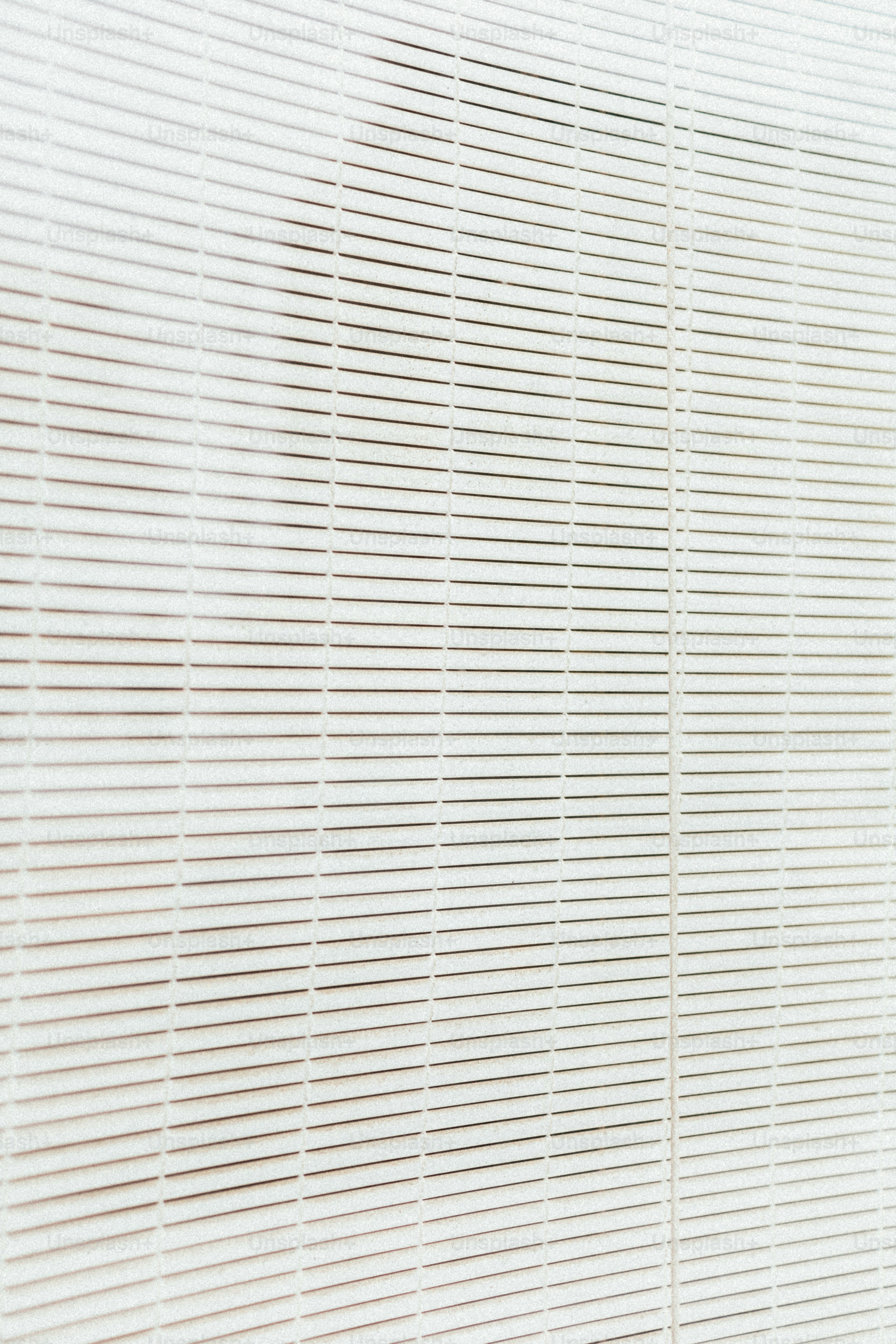 a man in a suit and tie standing in front of a window