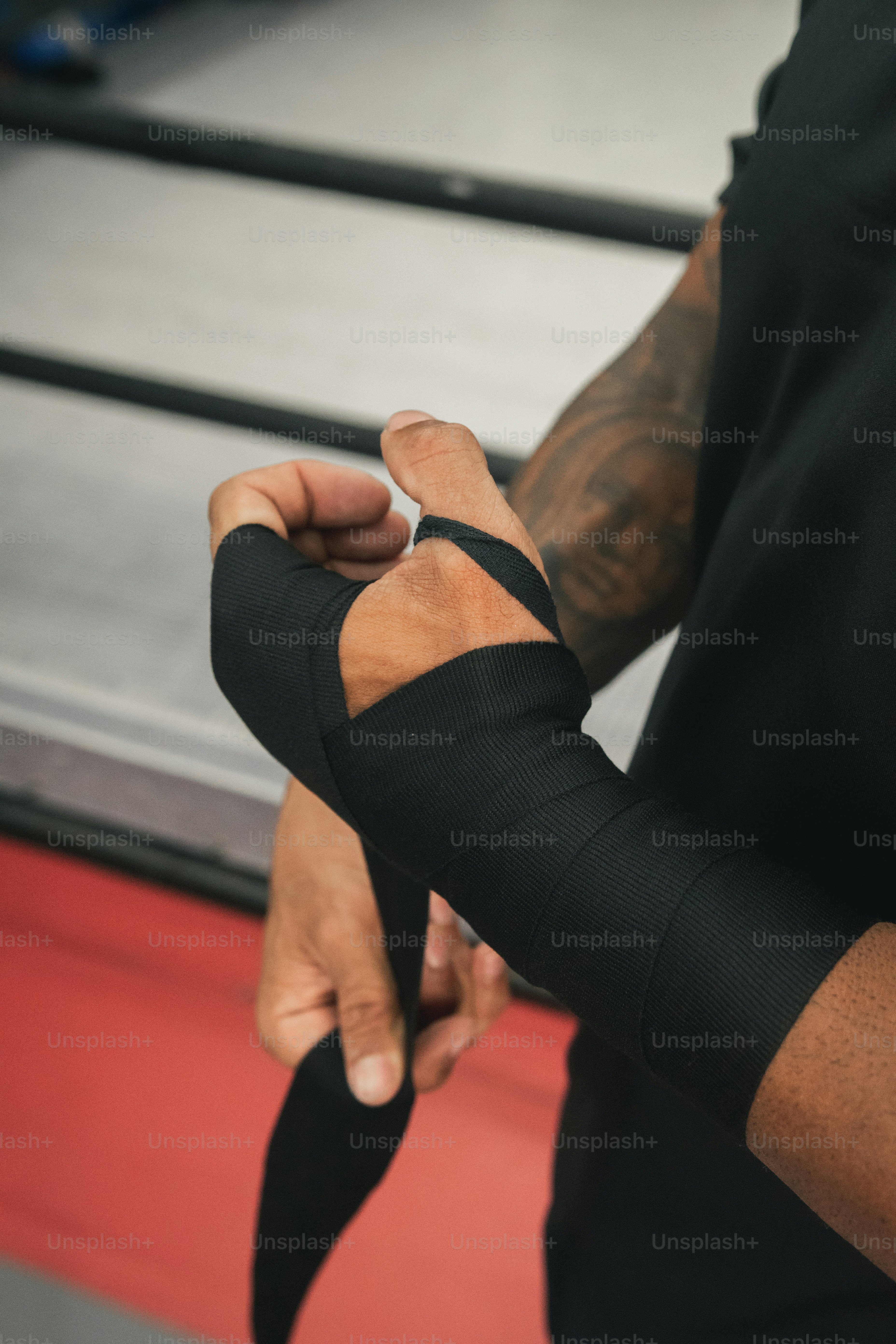a man wearing a black shirt and a pair of arm sleeves