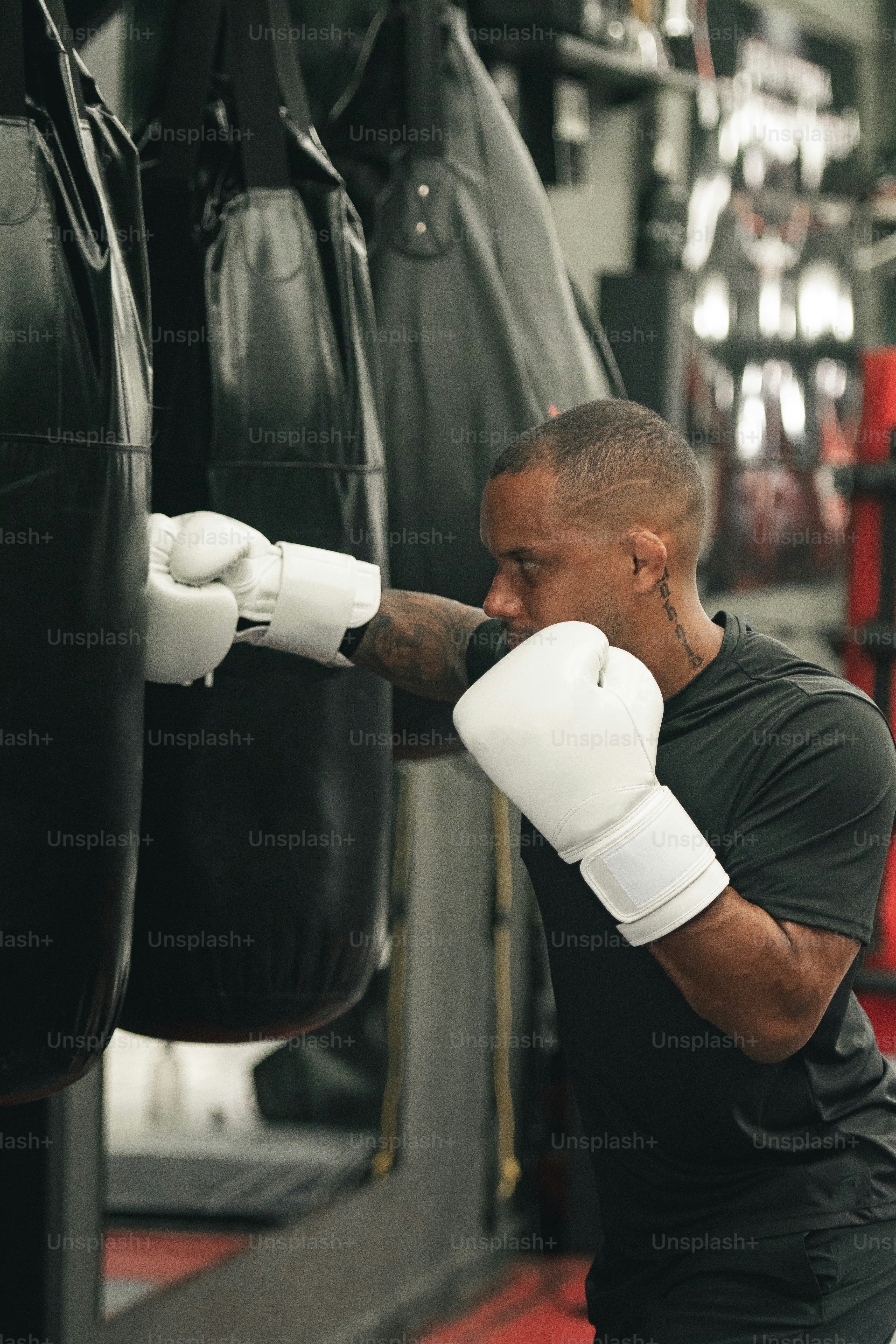 a man in a black shirt and white boxing gloves