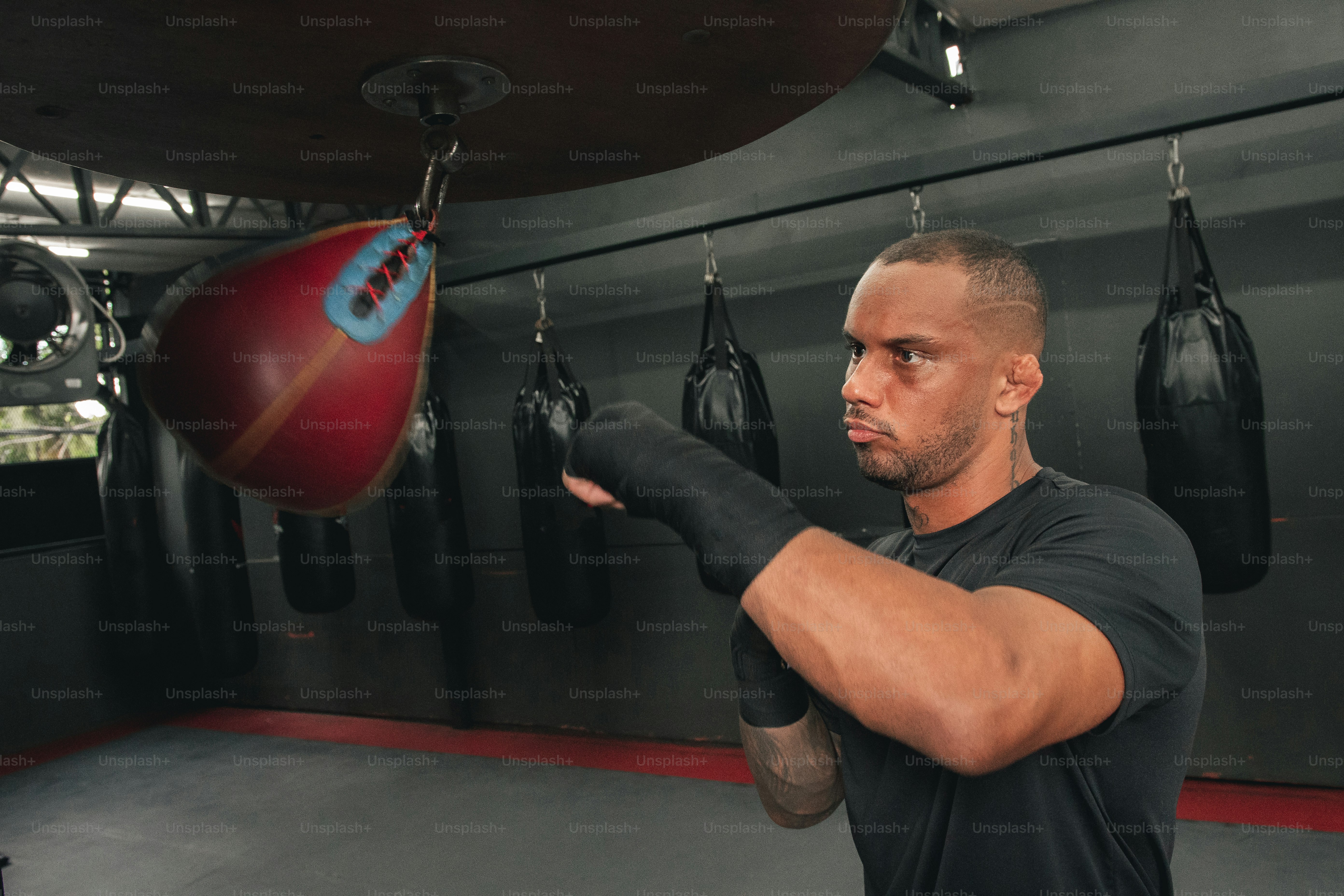 a man in a black shirt and boxing gloves