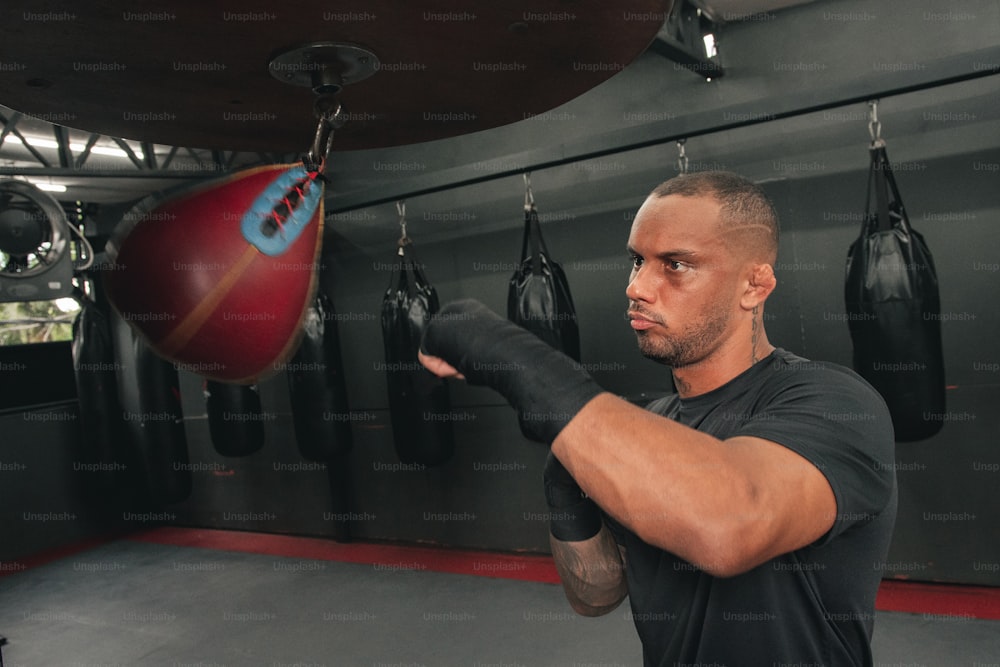 a man in a black shirt and boxing gloves