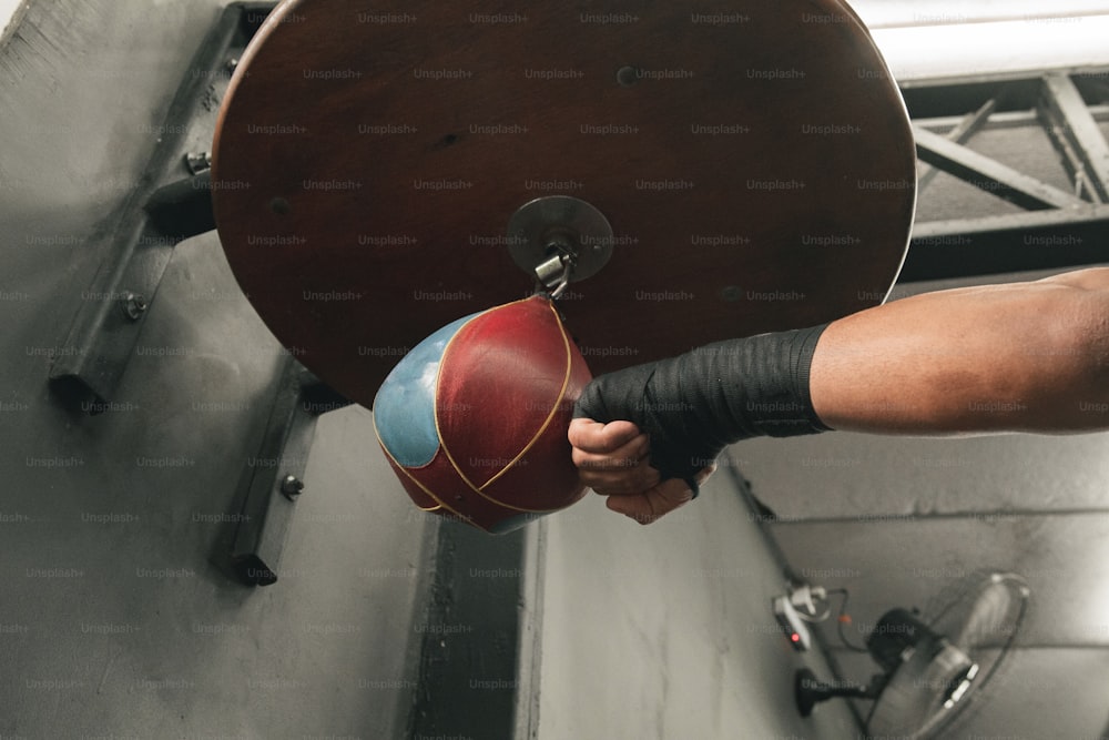 a person is holding a red and blue ball