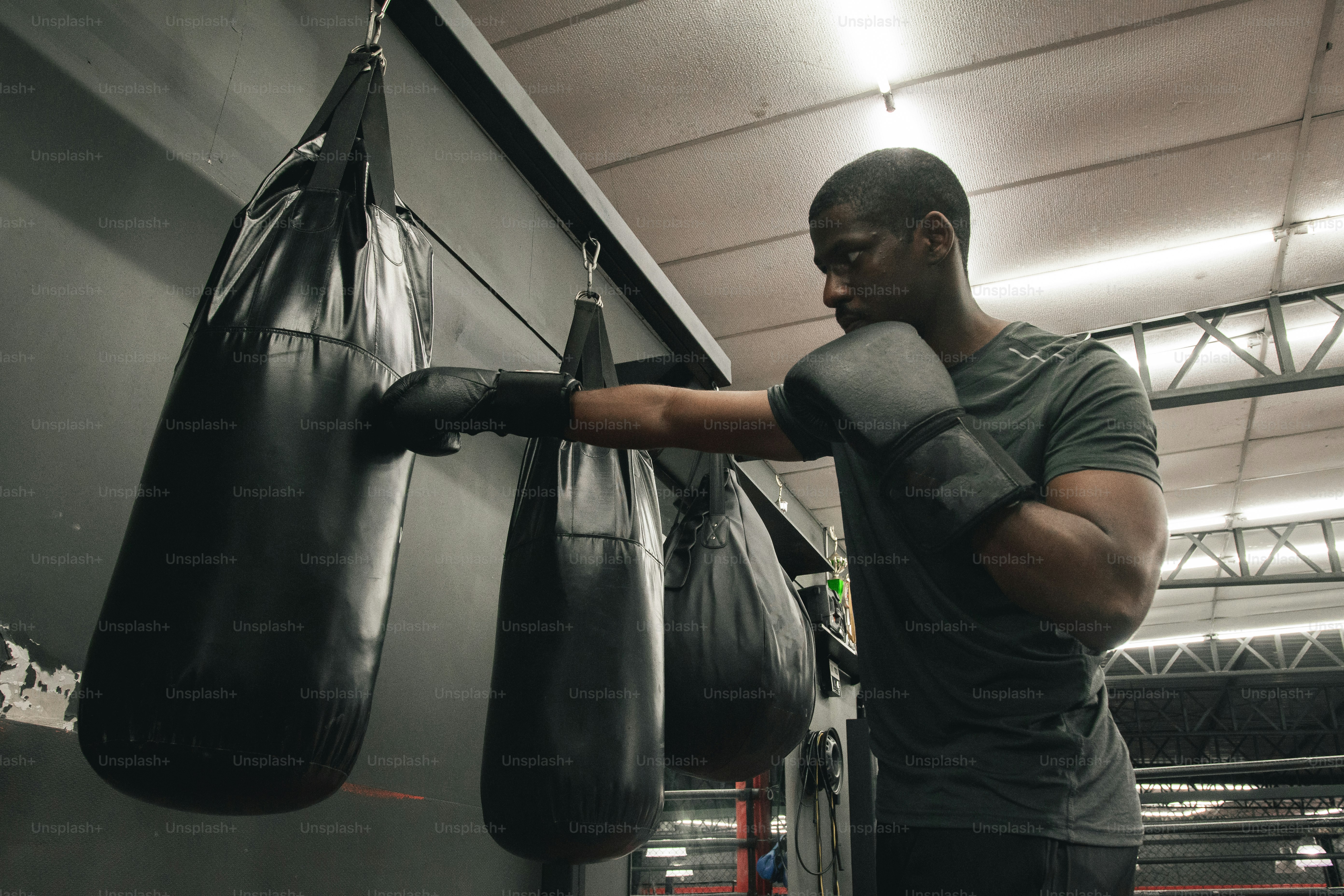 a man in a gym with a punching bag