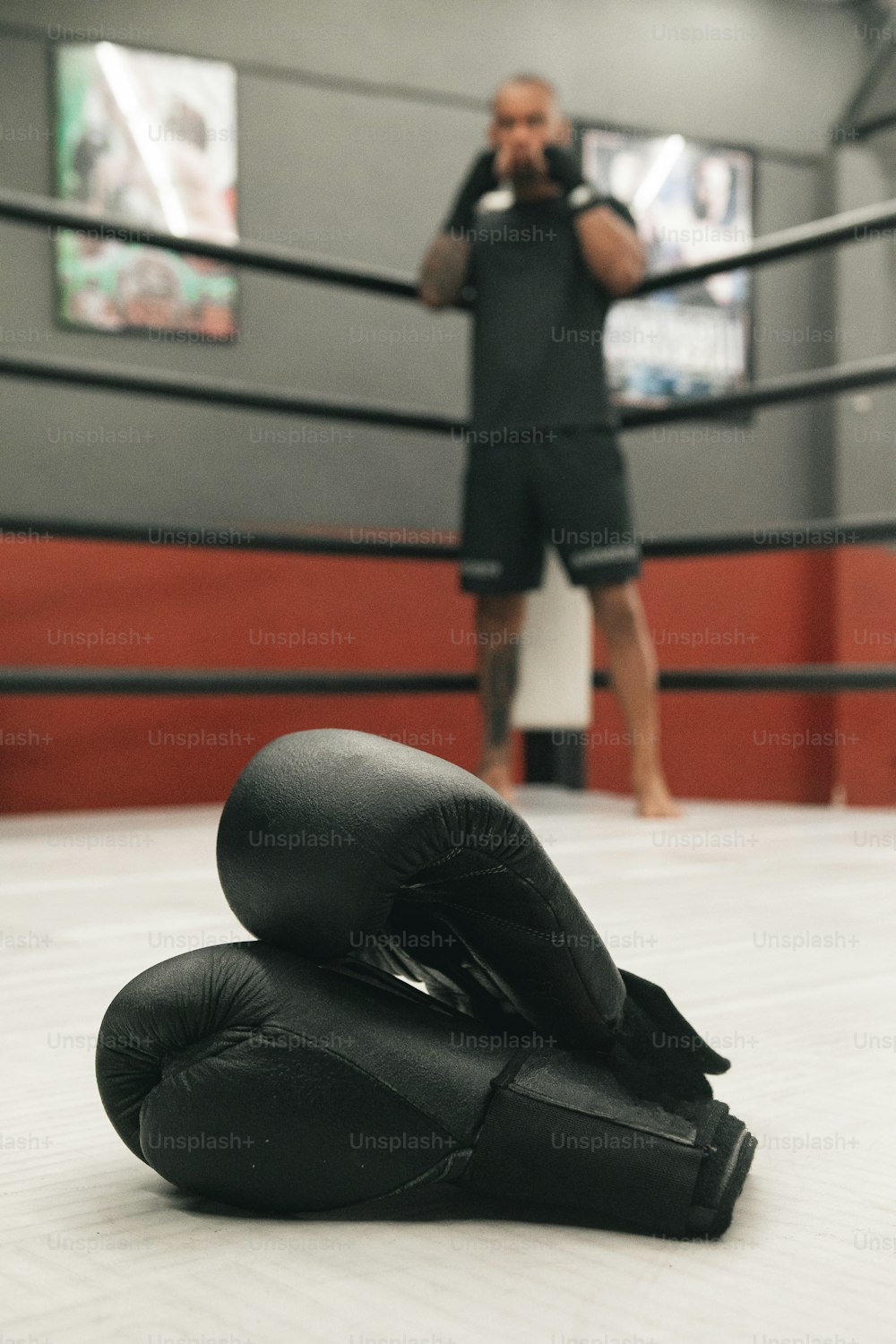 a man taking a picture of his boxing gloves