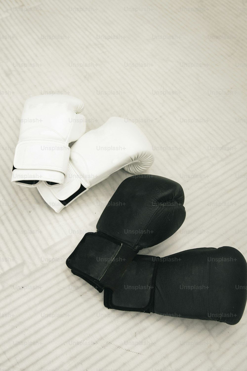 a pair of black and white boots sitting on top of a bed