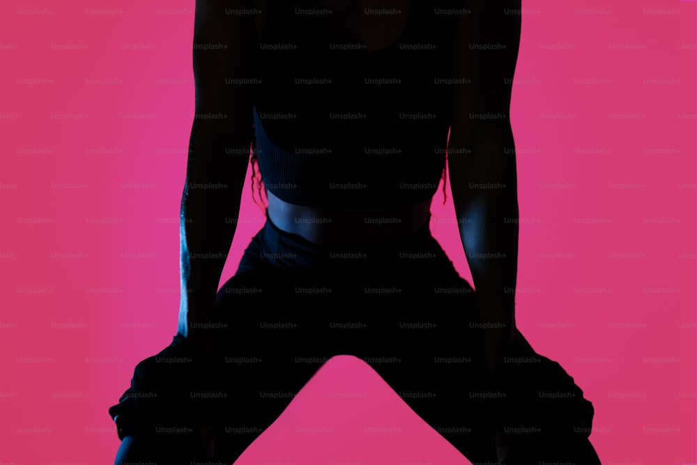 a silhouette of a woman in a black top
