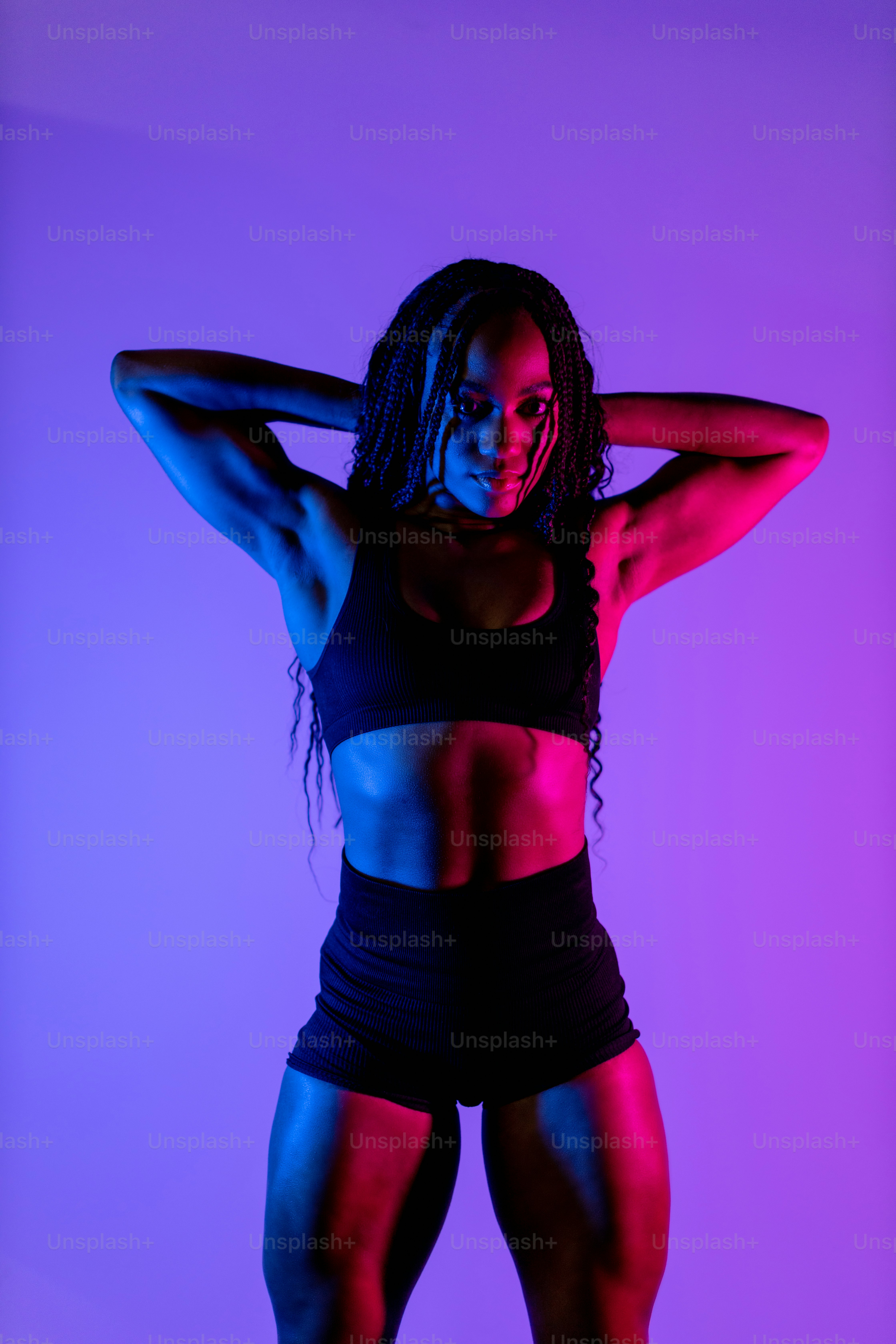 a woman in a black sports bra top and shorts